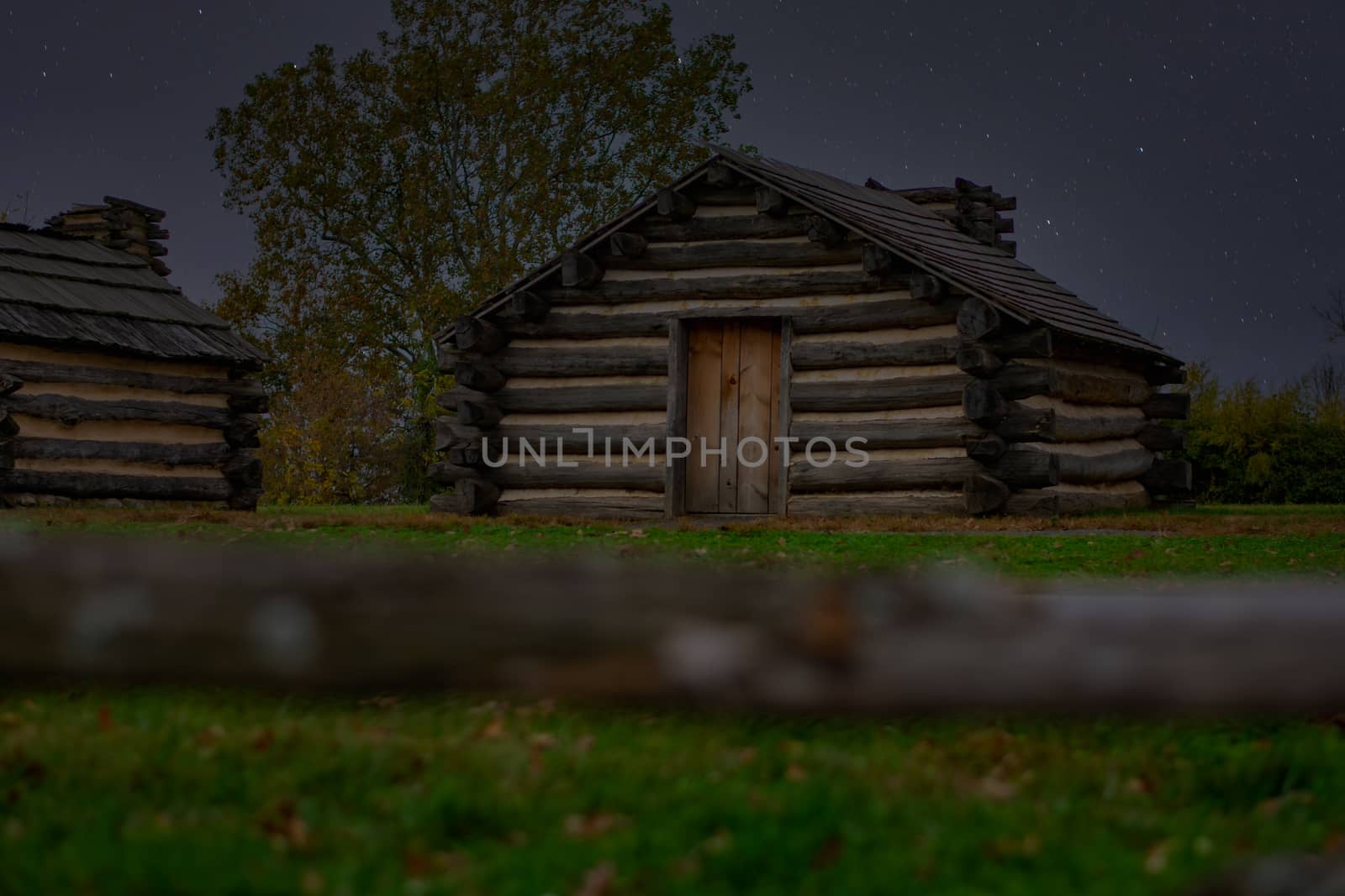 Reproduction Log Huts at Valley Forge Park at Night With Stars by bju12290