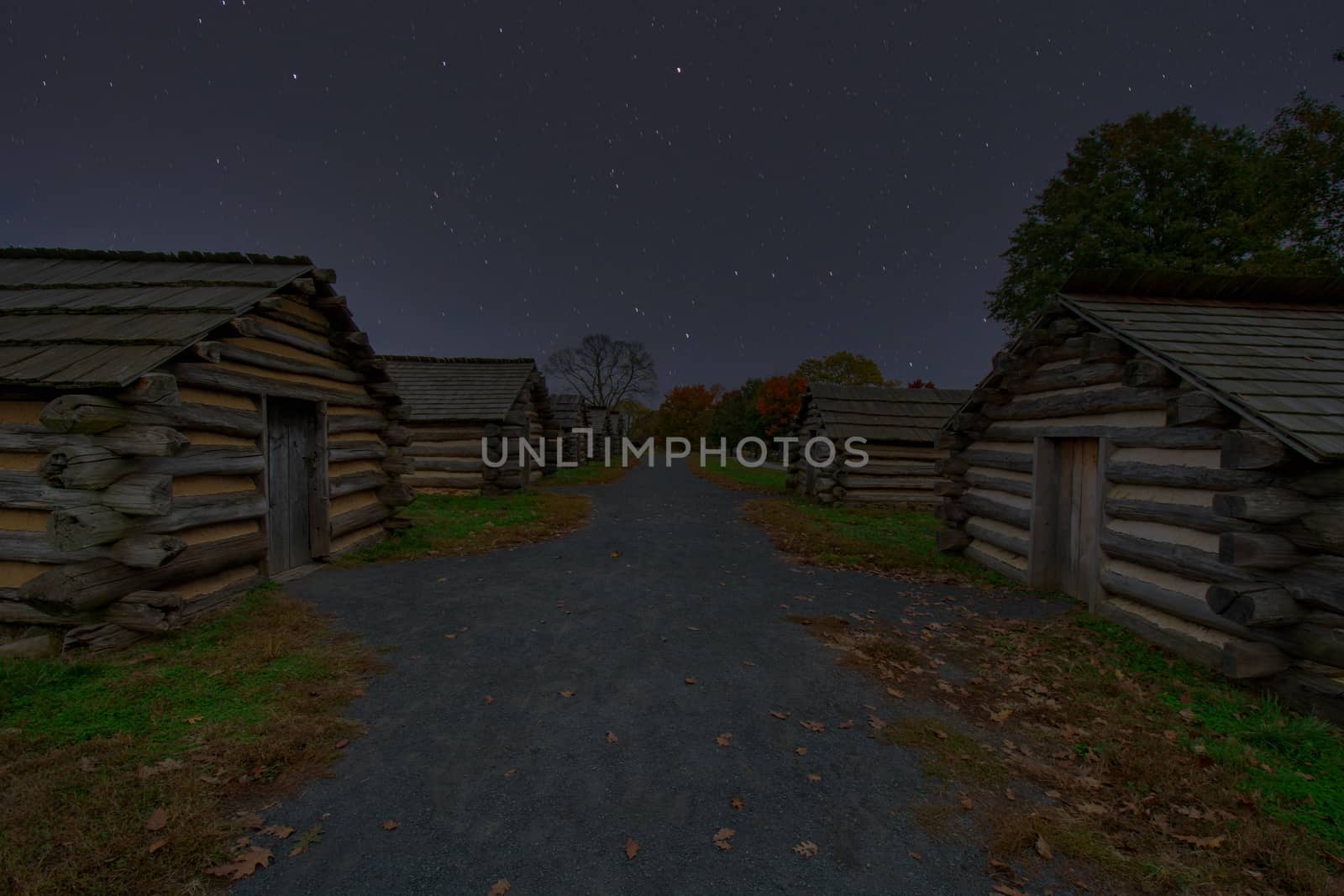 Reproduction Log Huts at Valley Forge Park at Night With Stars by bju12290