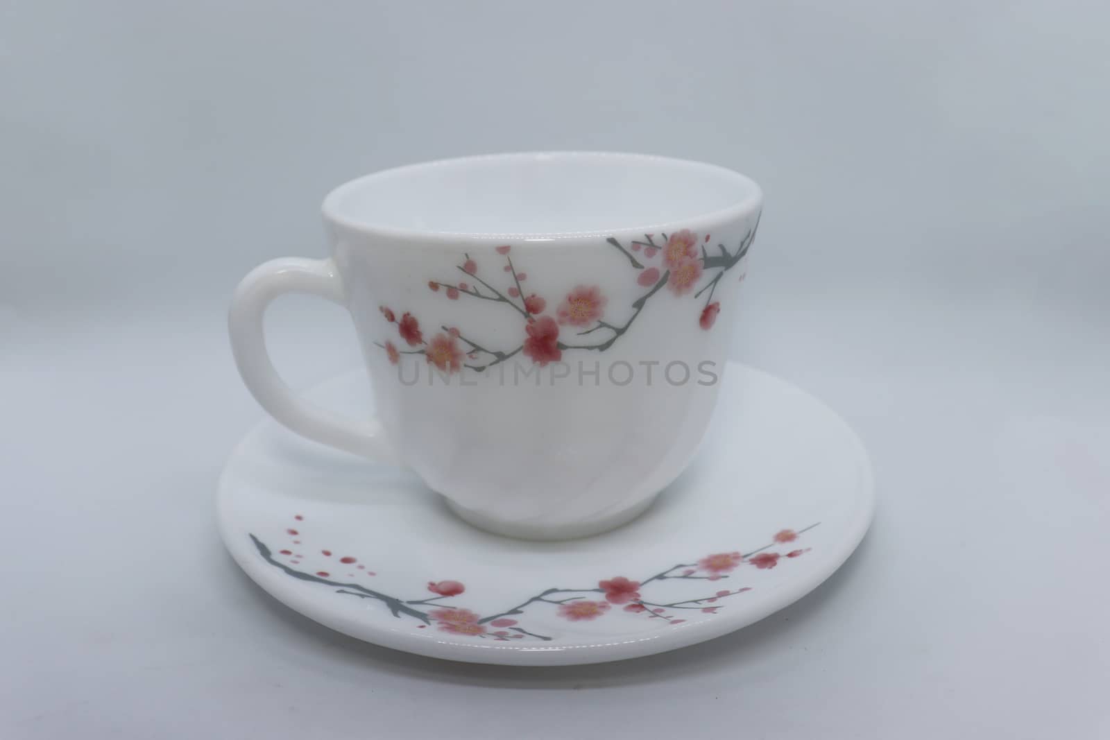 ceramic cup and plate closeup on white background