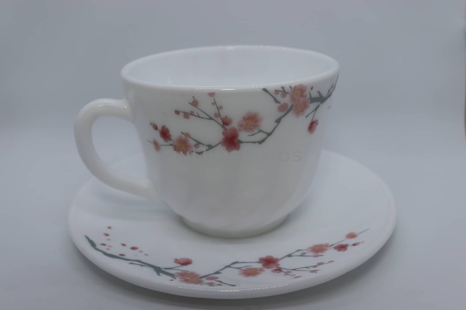 ceramic cup and plate closeup on white background