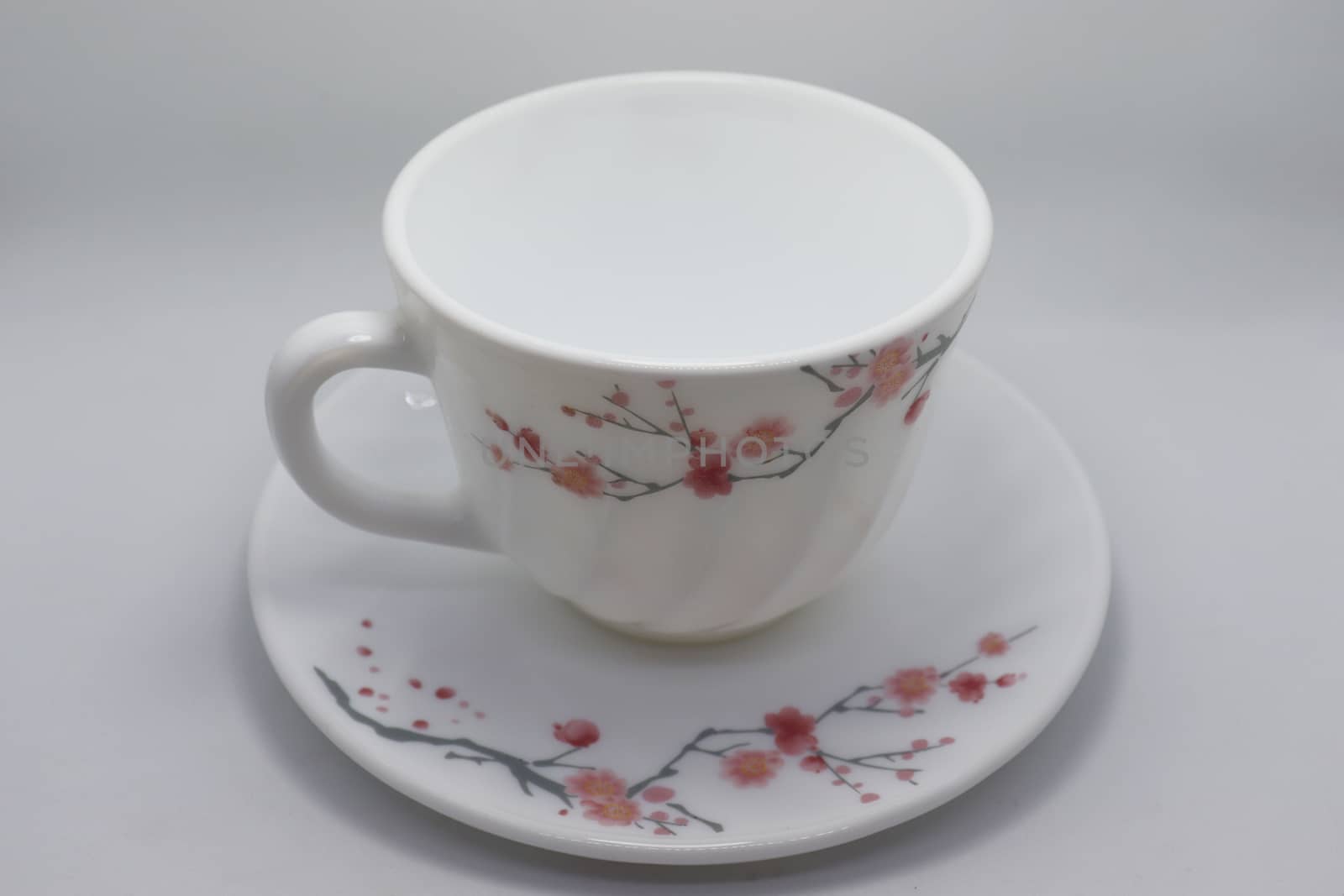 ceramic cup and plate closeup on white background