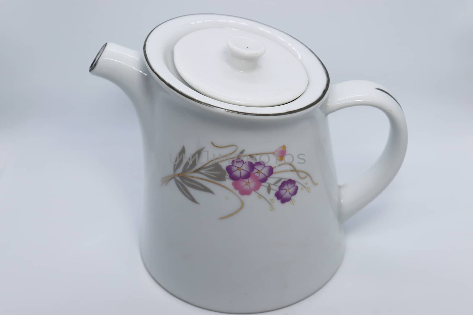 ceramic tea kettle closeup on white background