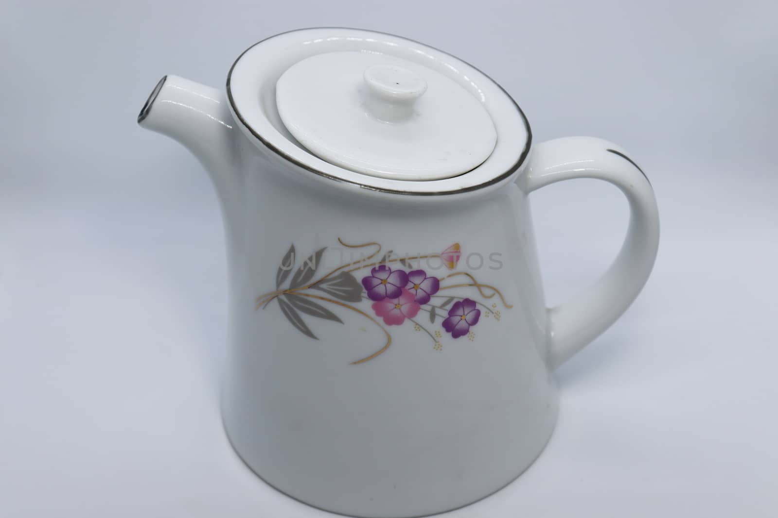 ceramic tea kettle closeup on white background
