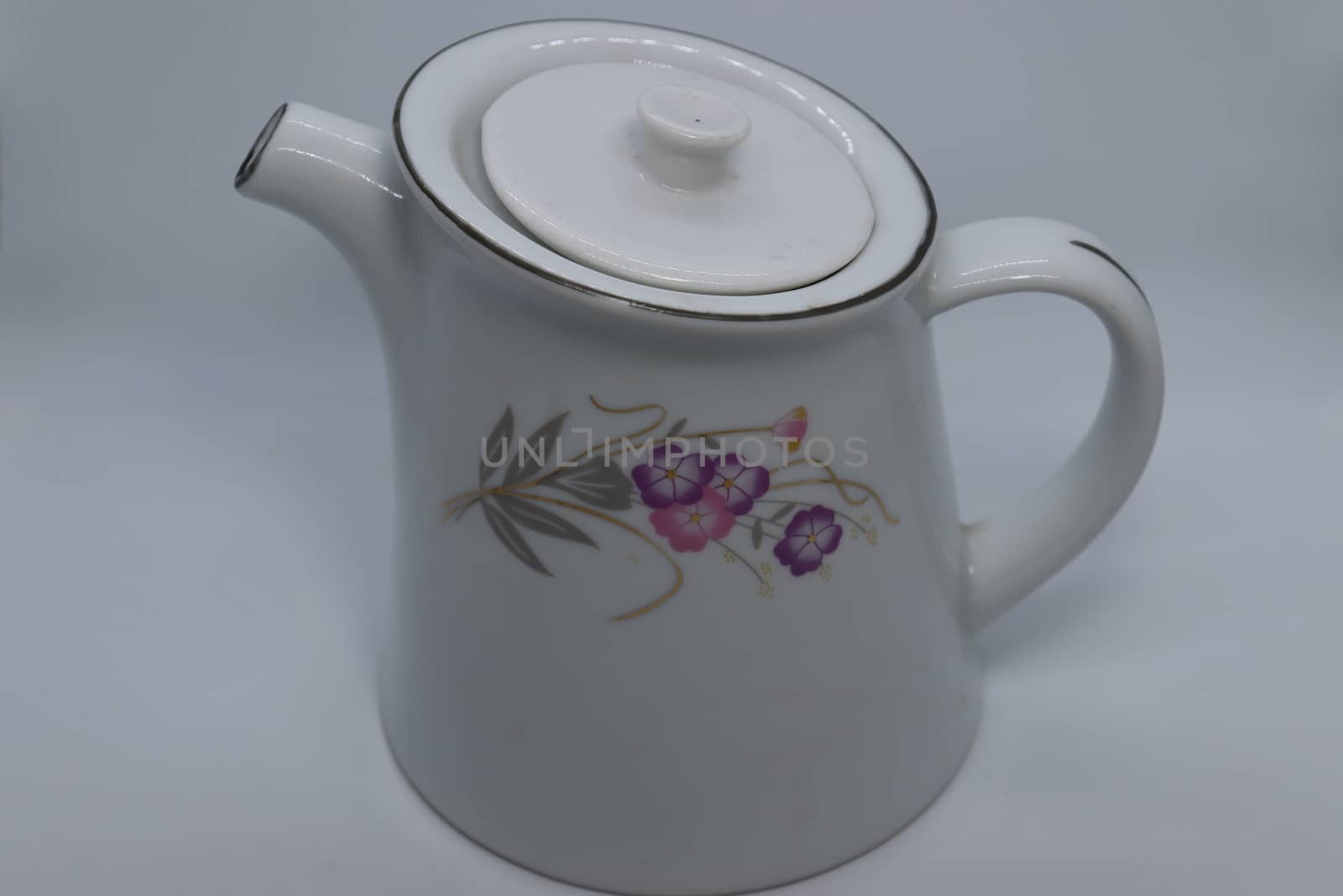 ceramic tea kettle closeup on white background