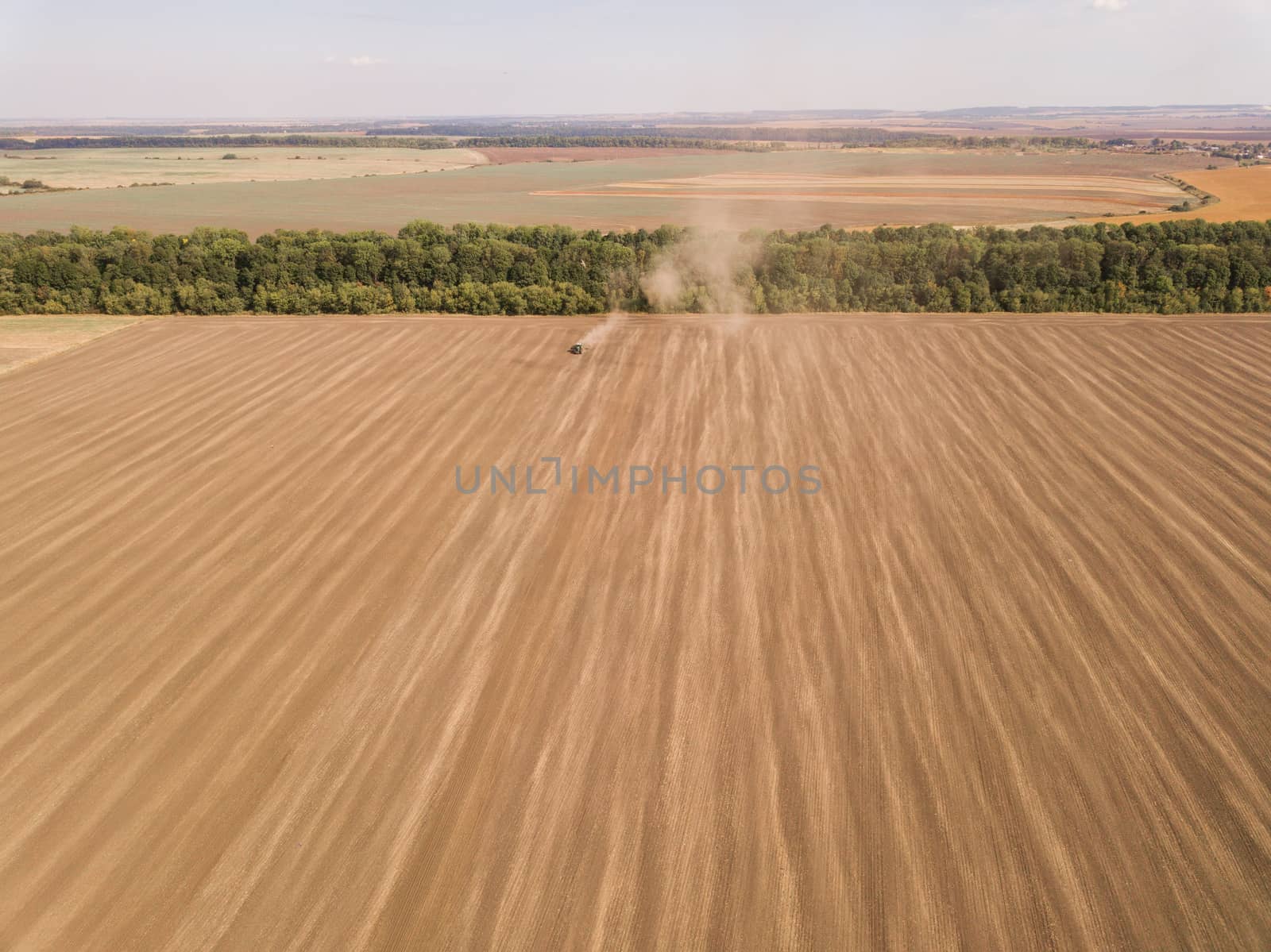 Harvesting in the Golden Wheat field. Aerial view. A Lot of Land by TrEKone