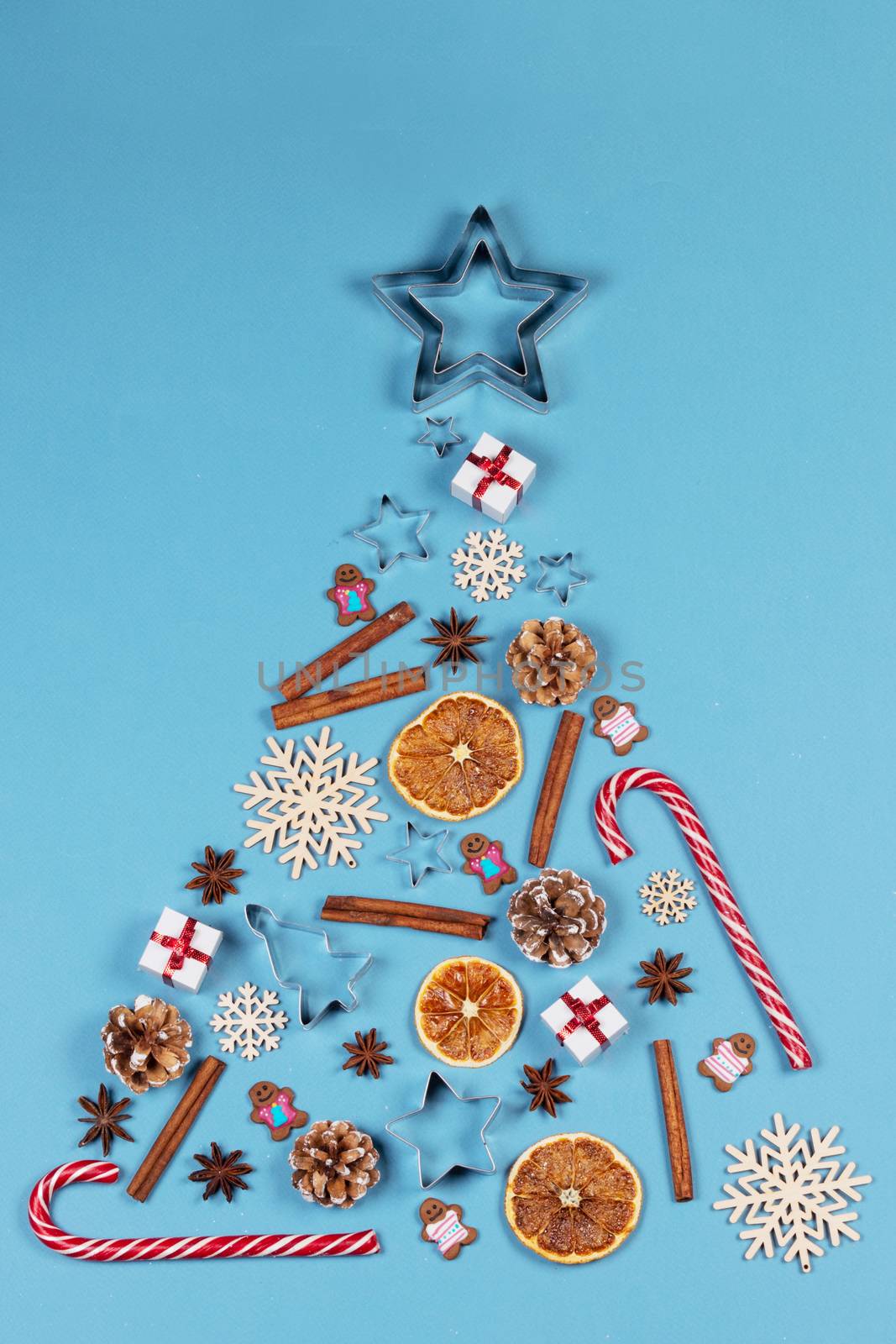 Christmas Tree made of decor on blue paper background. Christmas Holiday Concept. Flat Lay