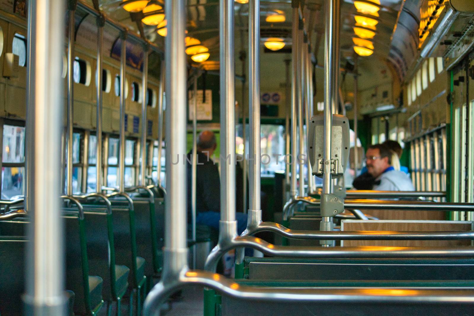 Historical cable car interior with incidental people in San Francisco, California, United States. by kb79