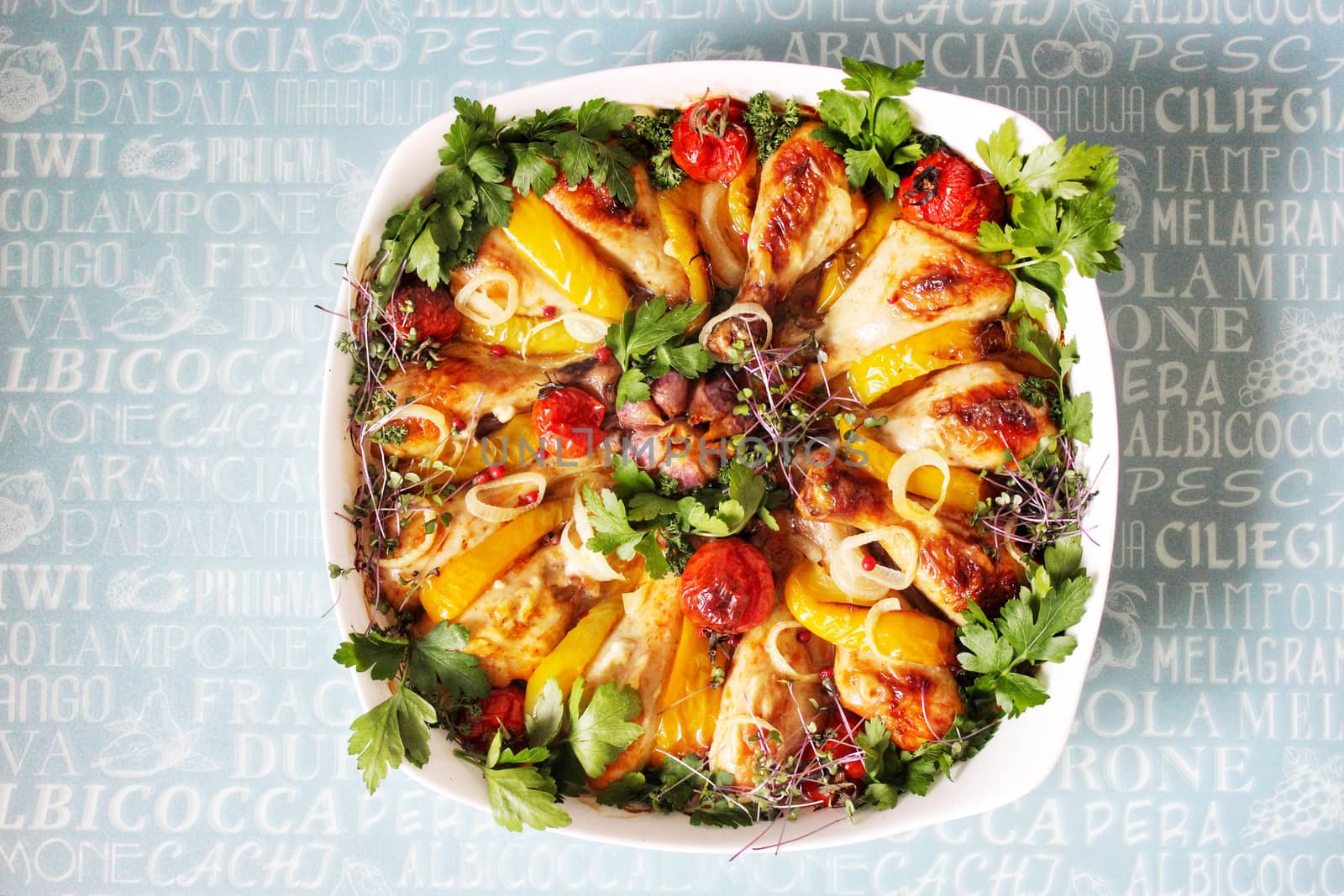 Fried breast and chicken drumsticks with vegetables and herbs.Texture or background