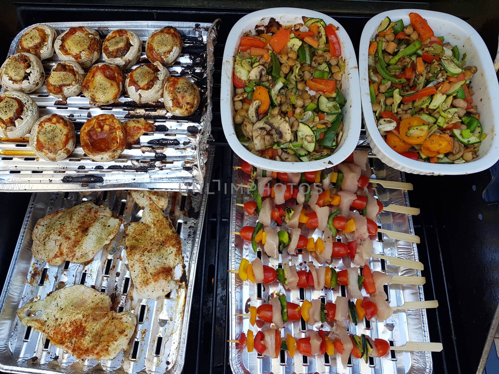 Grilled vegetables and meat on a barbecue grill , top view