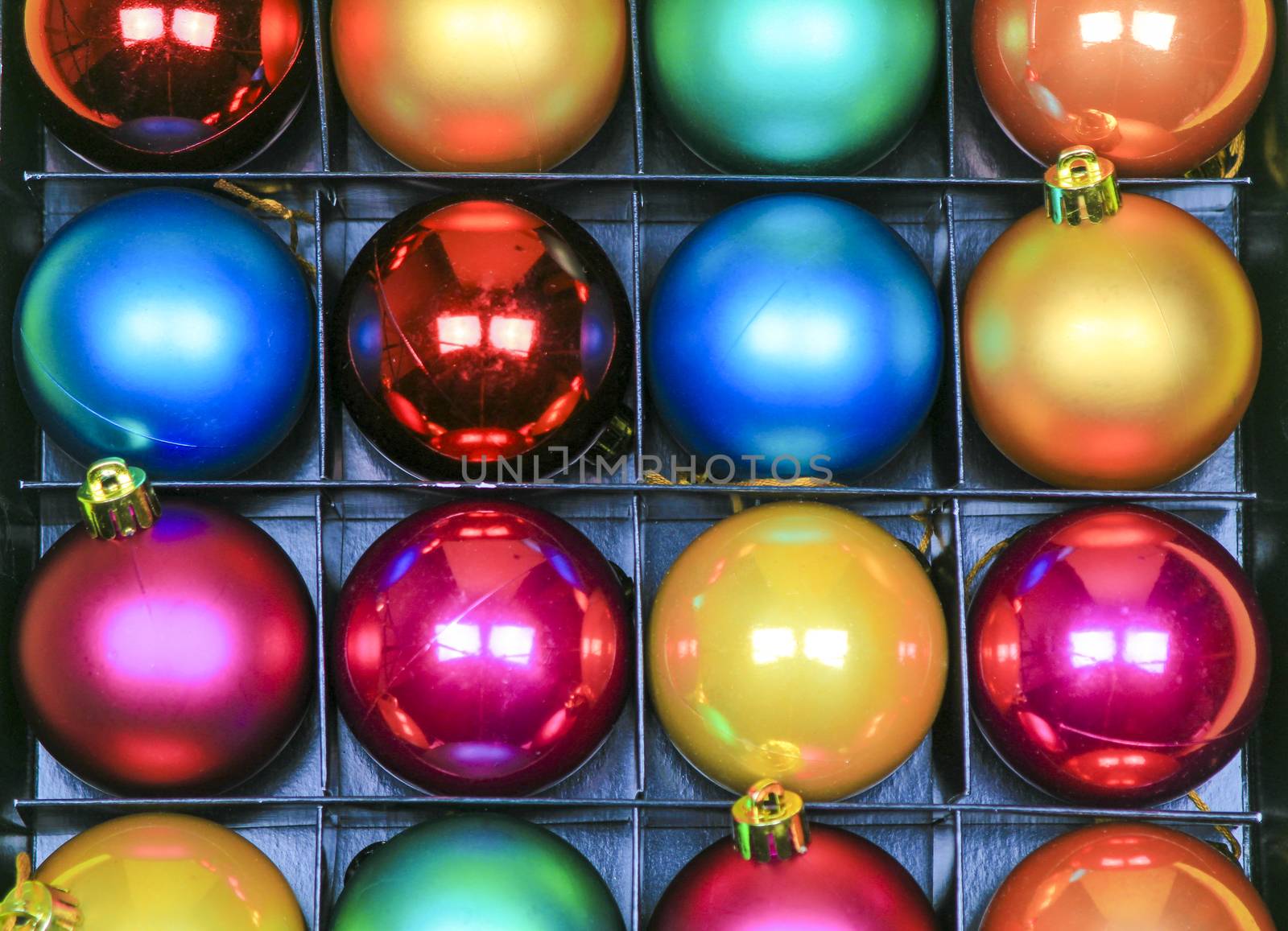 Box of multicolor Christmas balls in a row