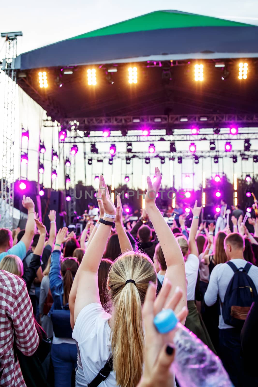 People with raised hands at summer music festival. Concert pleasure