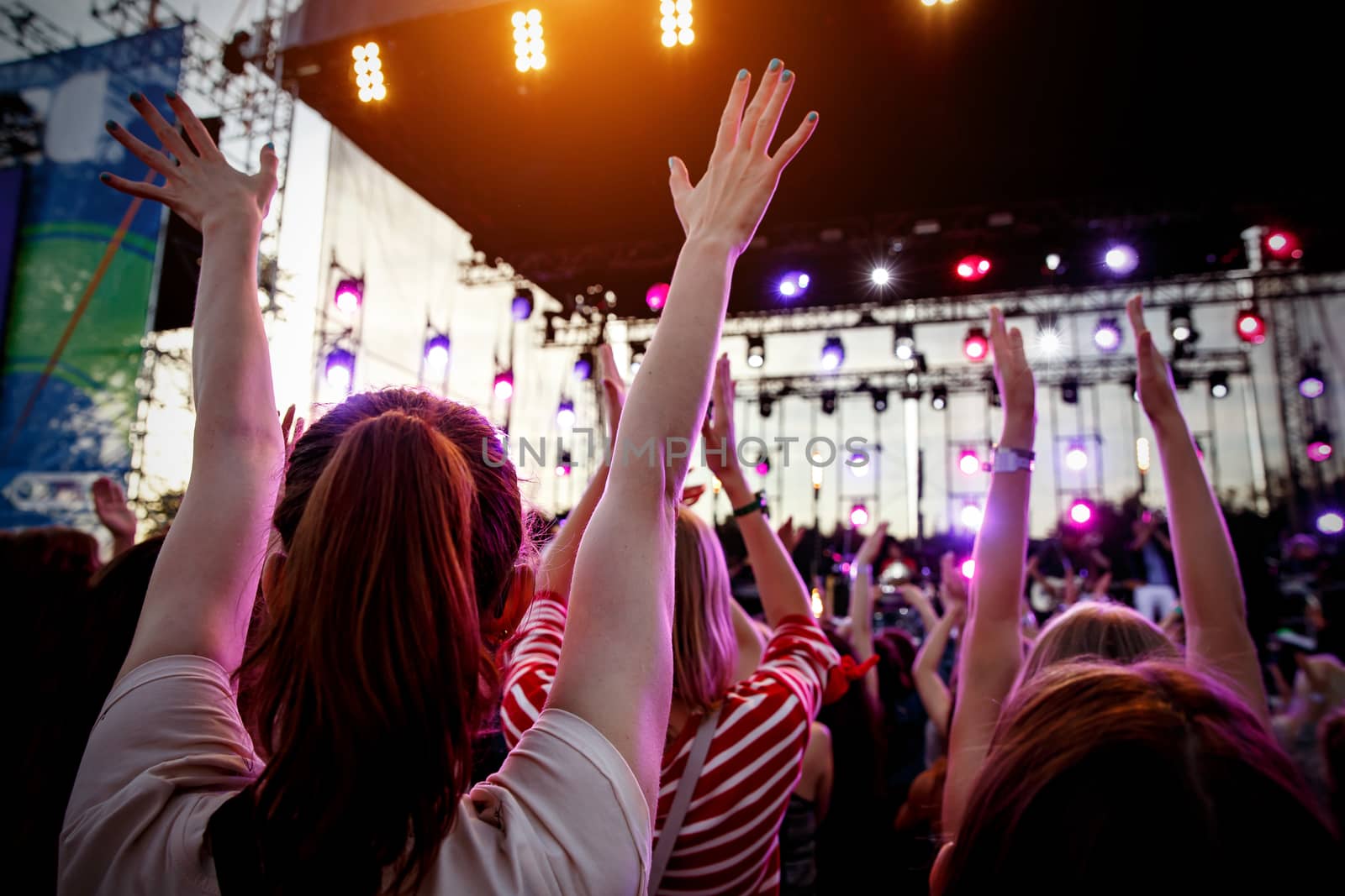 People with raised hands at summer music festival. Concert pleasure