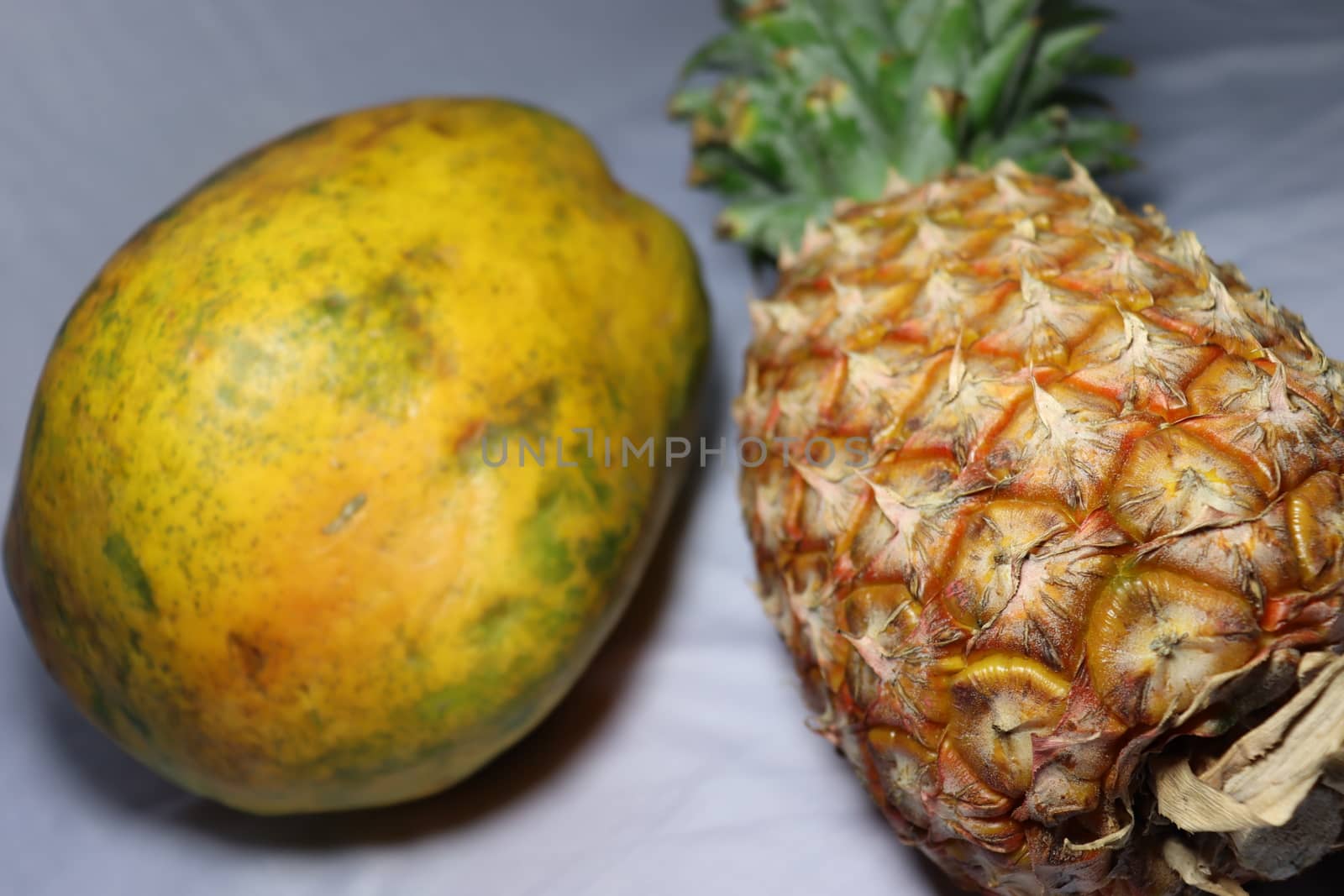 tasty healthy papaya and pineapple closeup