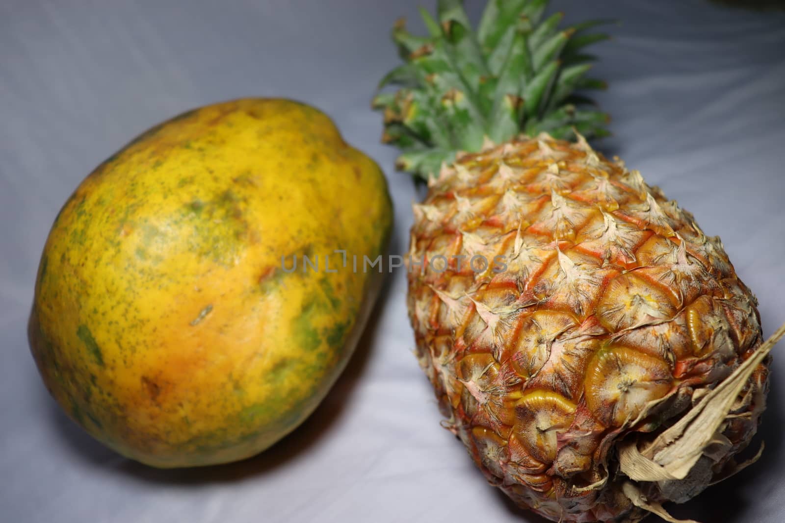 tasty healthy papaya and pineapple closeup