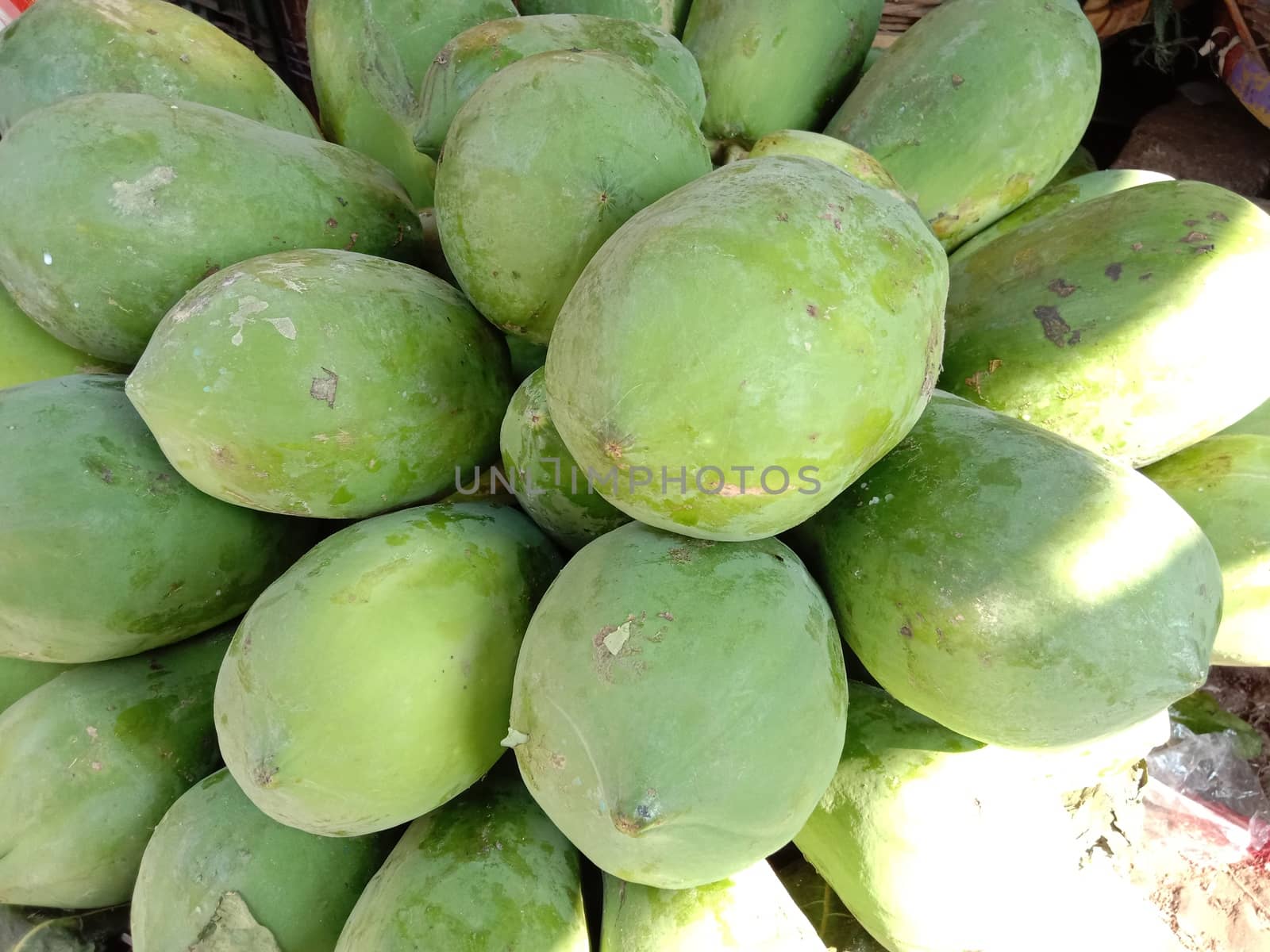 green colored raw papaya stock on shop