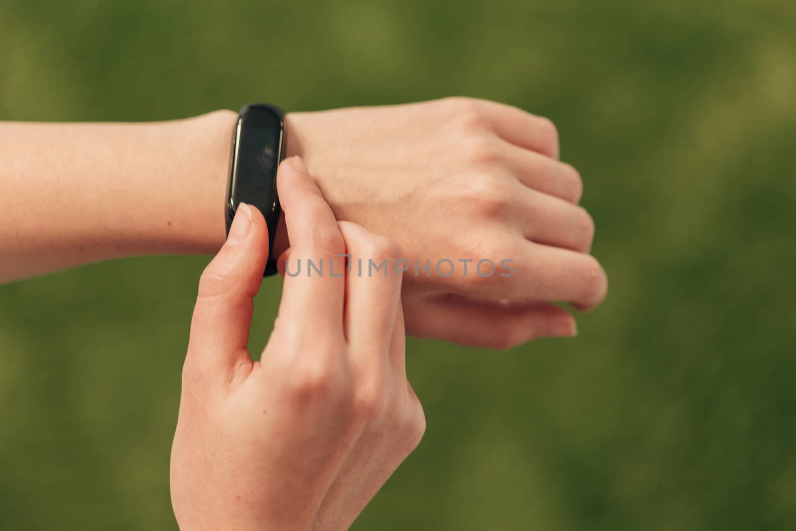 A smartwatch on hand measures the heartbeat. Checking the pulse after fitness. by TrEKone