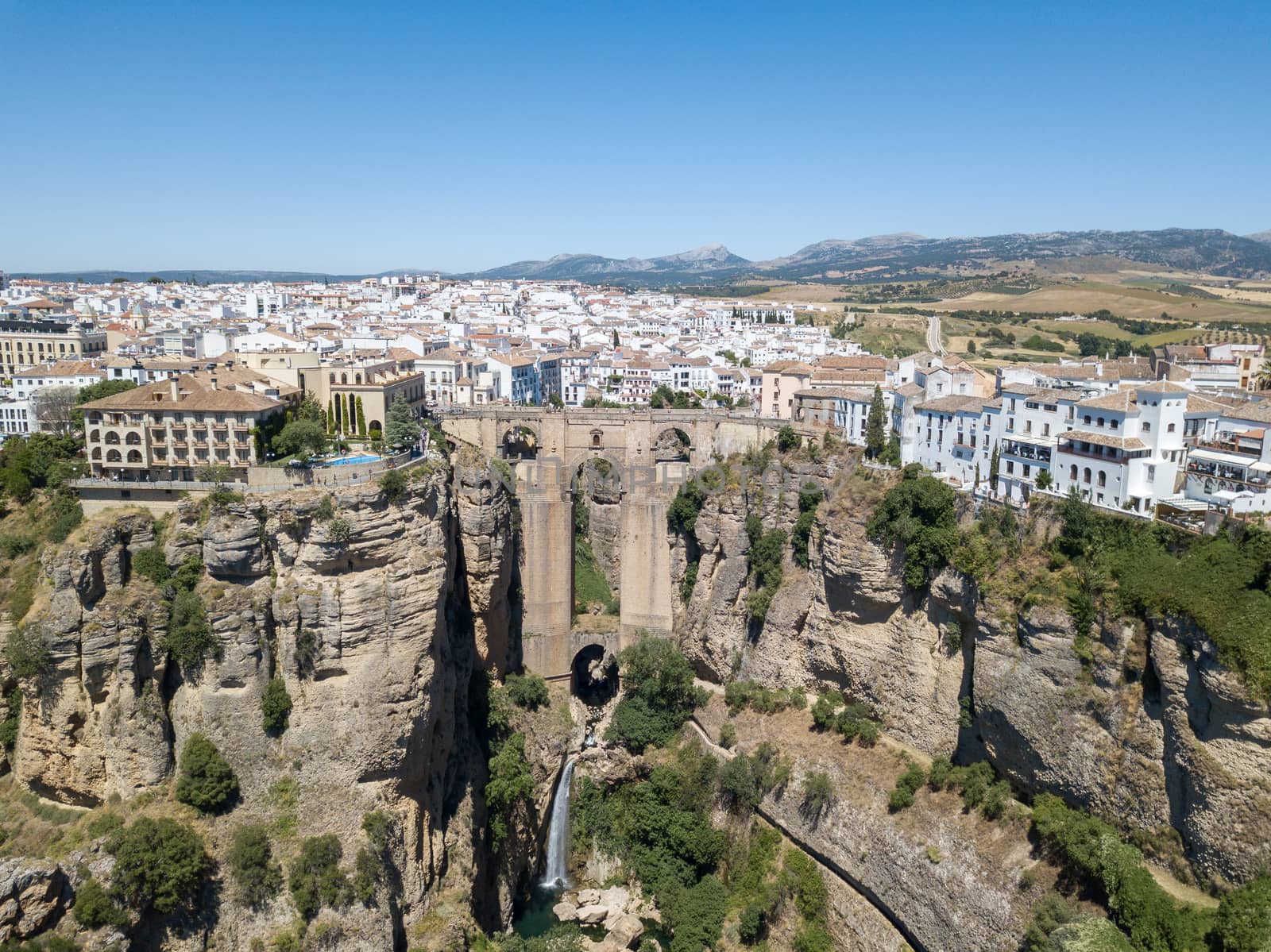 Ronda, Spain - May 31, 2019: Aerial Drone view of the famous bridge Puente Nuevo in the historic city centre.