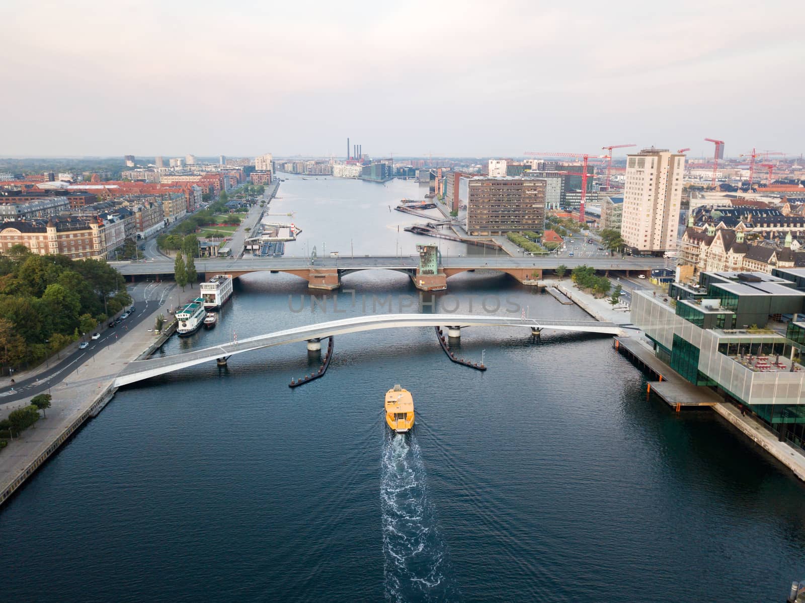 Copenhagen, Denmark - August 27, 2019: Aerial drone view of the old bridge Langebro and the modern pedestrian and cycling bridge Lille Langebro.