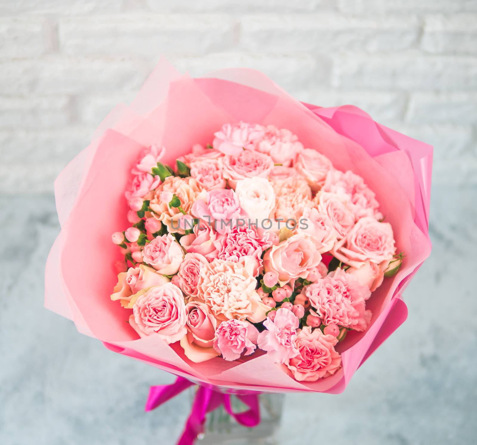 Close up view of nice subtle delicate pink bouquet with roses, dianthus, hypericum, clove. Shallow DOF. Copy space for text.