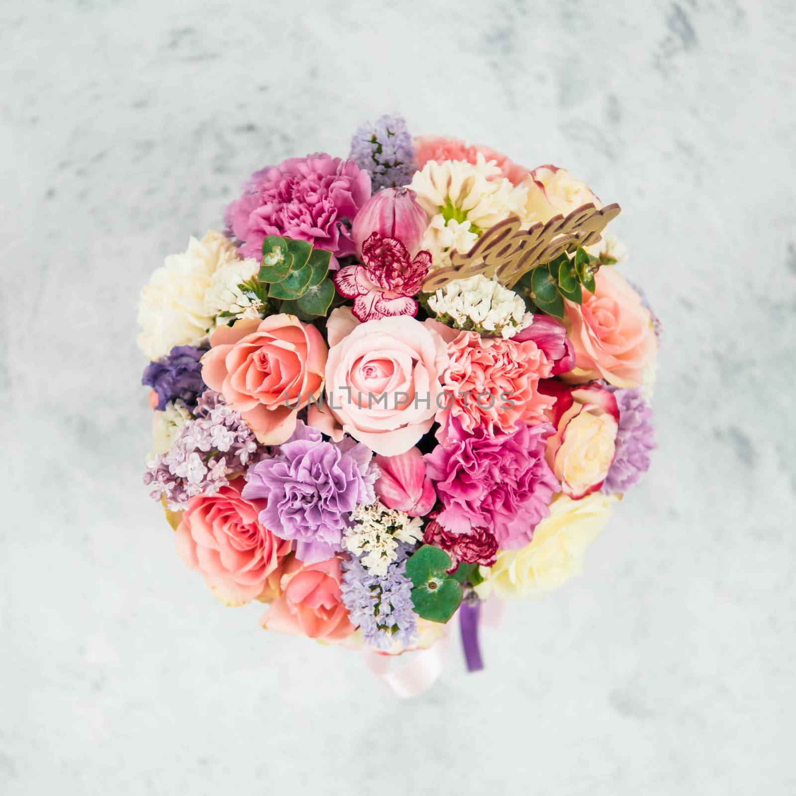 Beautiful bouquet with roses, dianthus, carnation bush, limonium, lilac, tulip. Bouquet with different flowers. Shallow DOF, copy space. Top view. Square format for social media