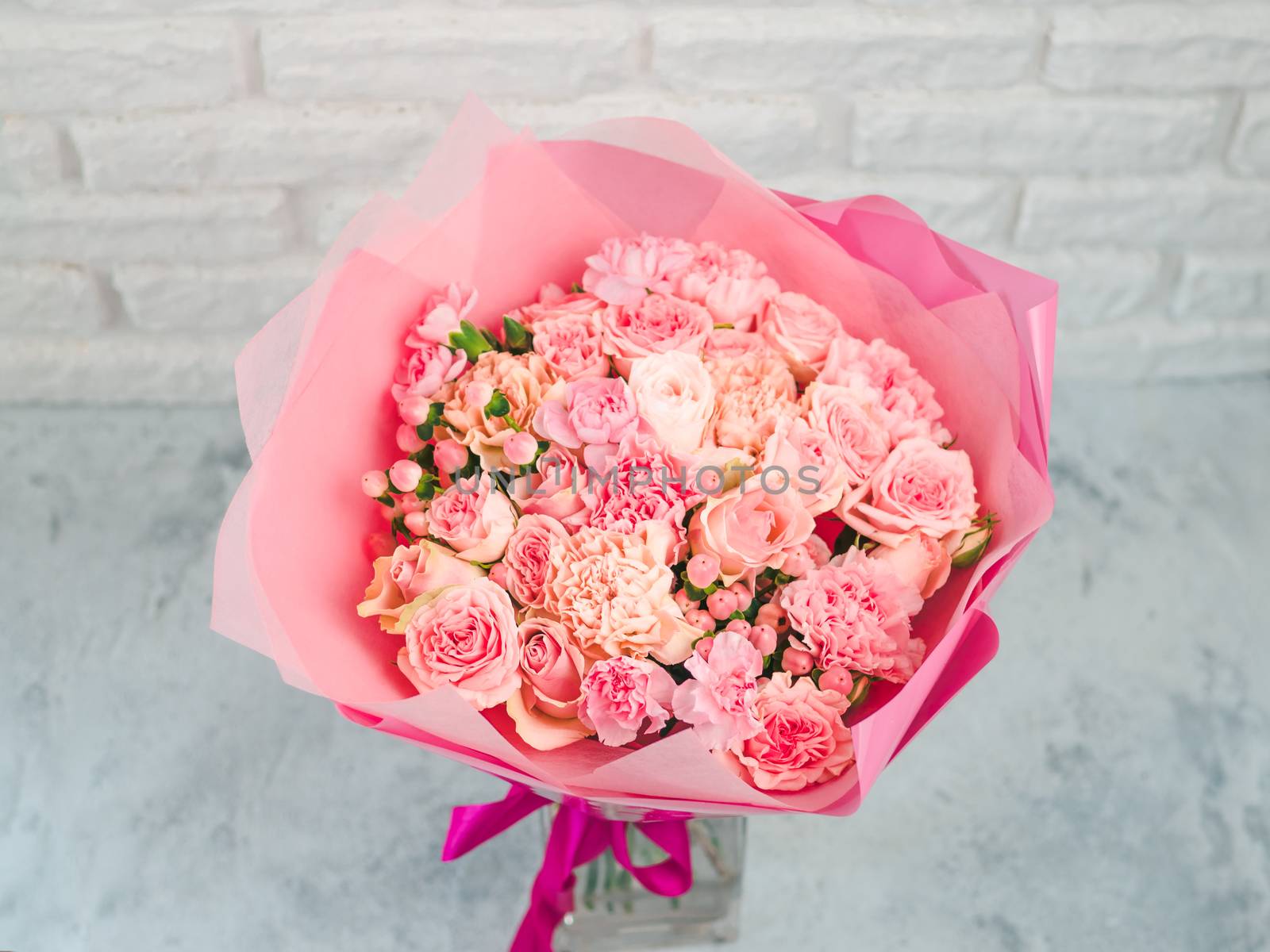 Close up view of nice subtle delicate pink bouquet with roses, dianthus, hypericum, clove. Shallow DOF. Copy space for text.