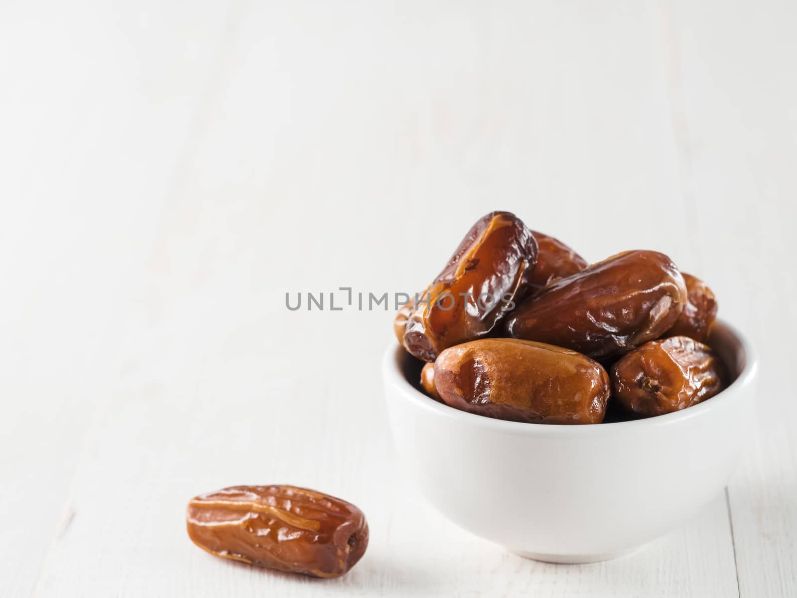 Plate of dried dates on table by fascinadora