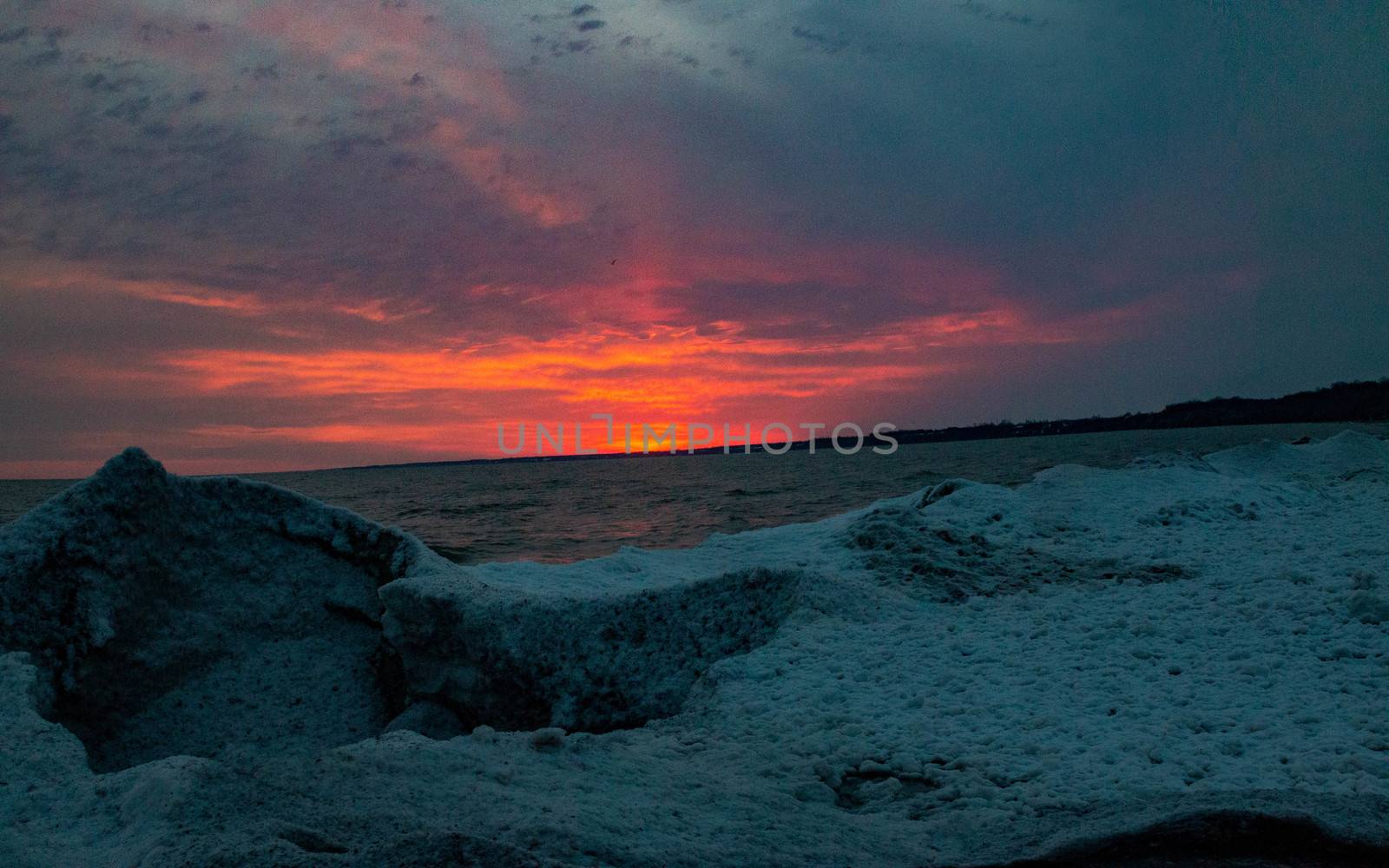 dramatic sunset at Port Stanley beach in the winter in Canada. High quality photo