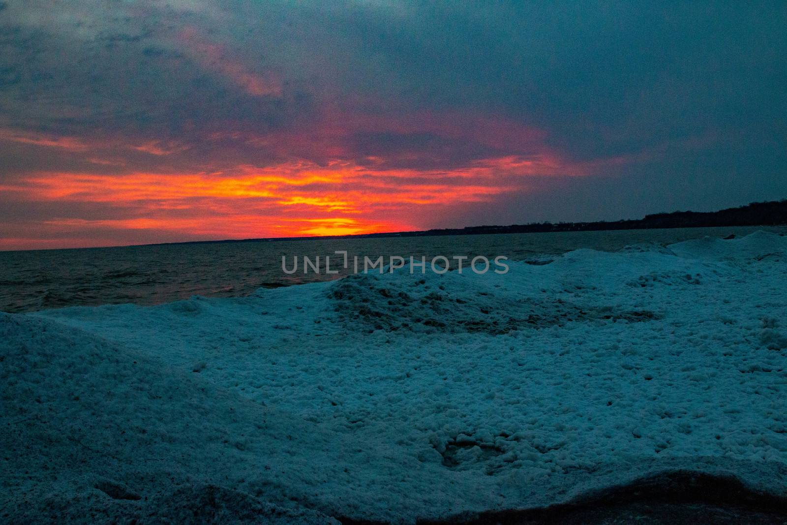 dramatic sunset at Port Stanley beach in the winter in Canada. High quality photo