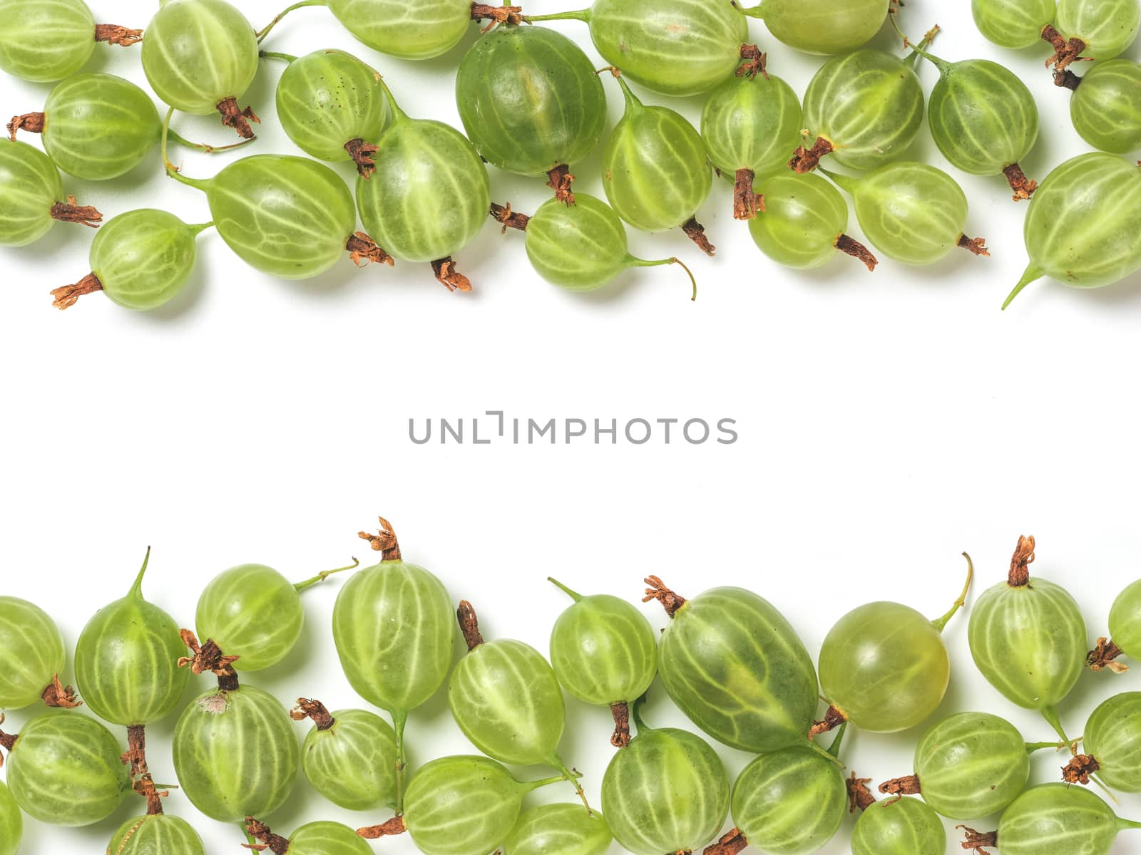 Ripe green gooseberry pattern. Creative layout made of organic gooseberries. Isolated on white with clipping path. Top view or flat lay. Copy space for text in center. Food concept.