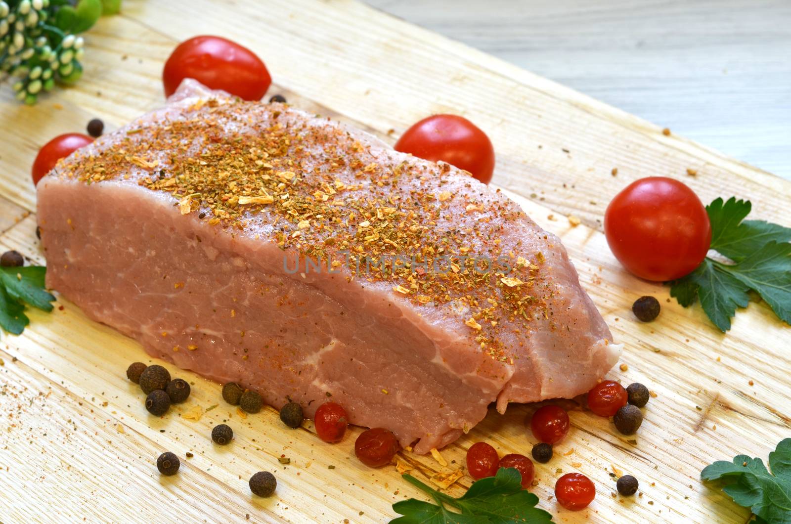 Raw pork meat on cutting board and vegetables and greens by lucia_fox