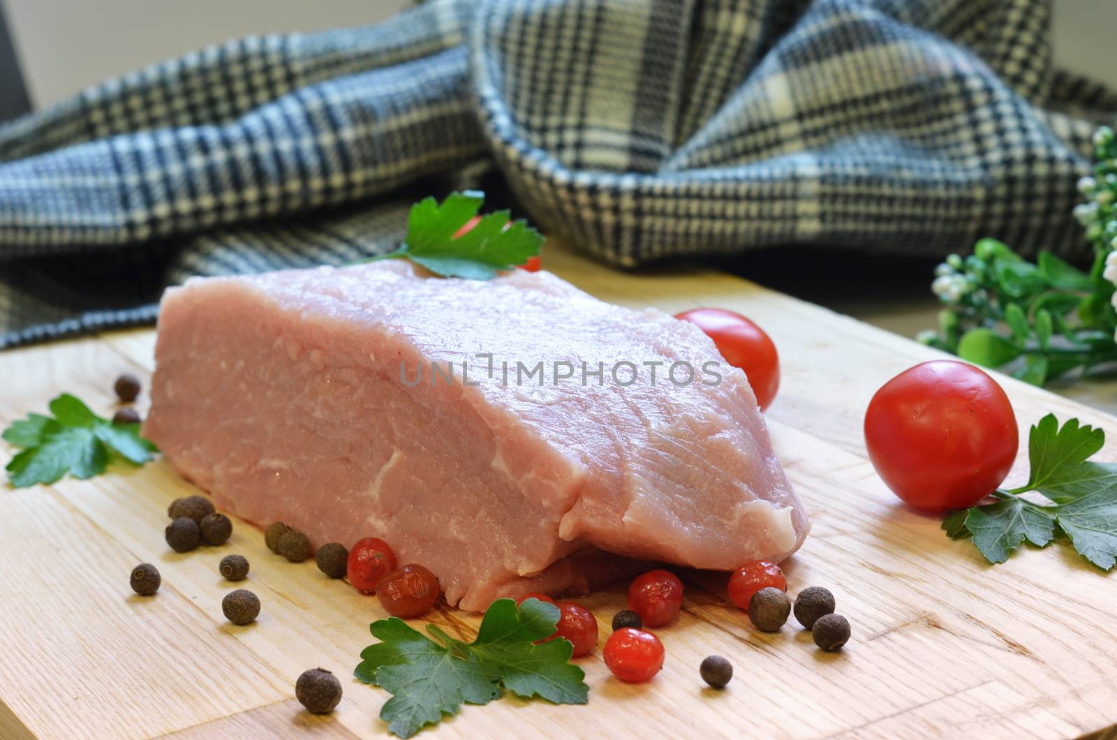 Raw pork meat on cutting board and vegetables and greens by lucia_fox