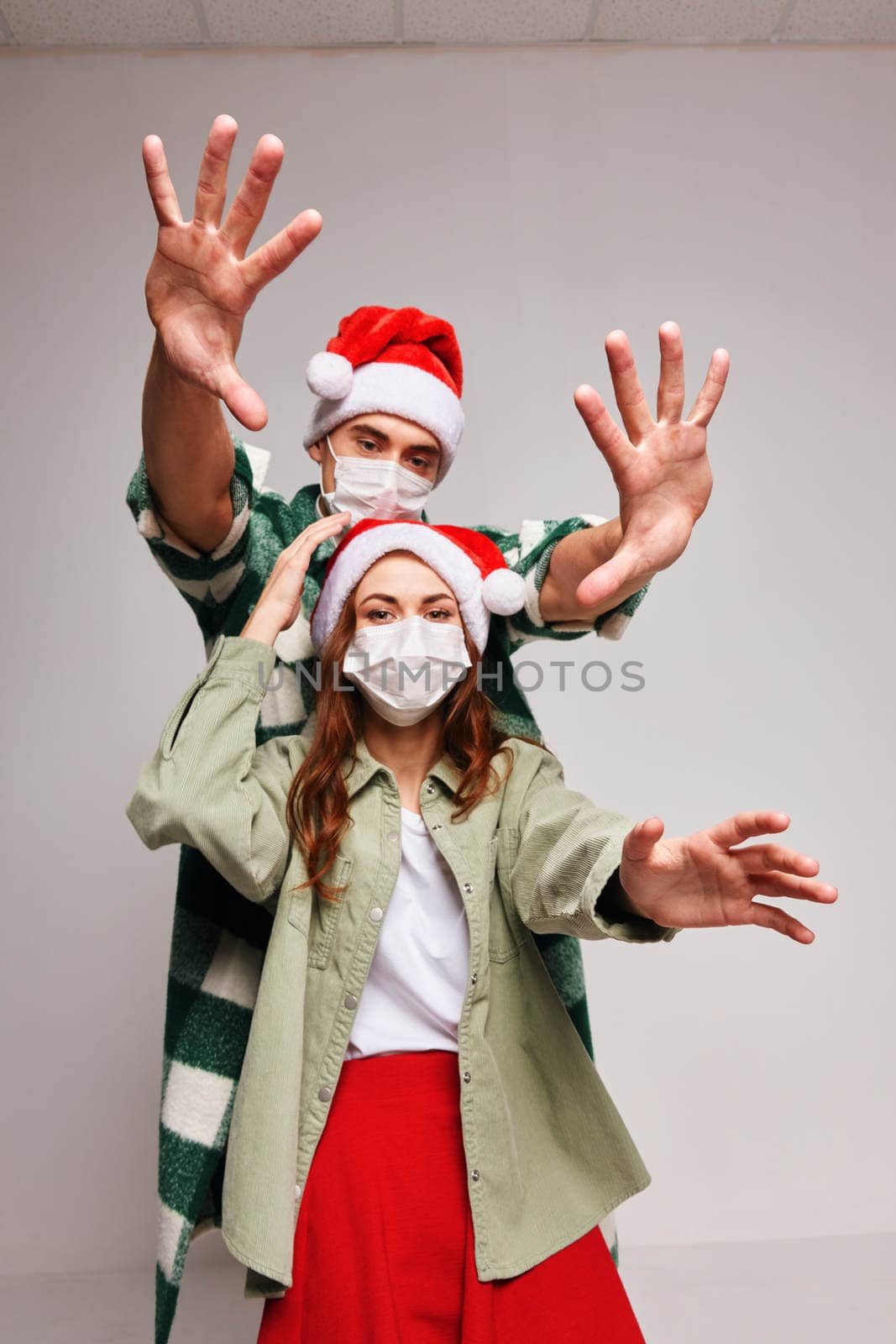 Man and woman in medical masks isolated holiday fun by SHOTPRIME