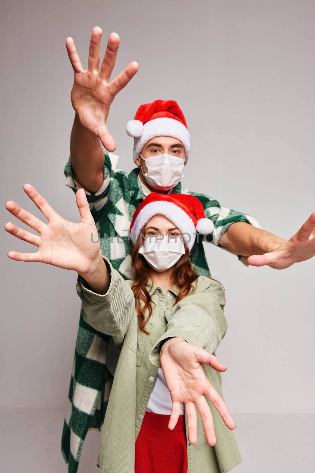 Gesturing hands holiday New Year medical mask fun. High quality photo