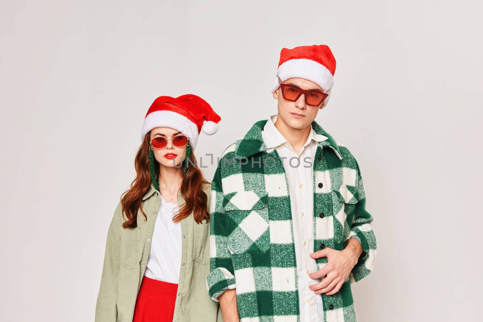 Man and woman in Santa hat Santa holiday Christmas Studio attractive look. High quality photo