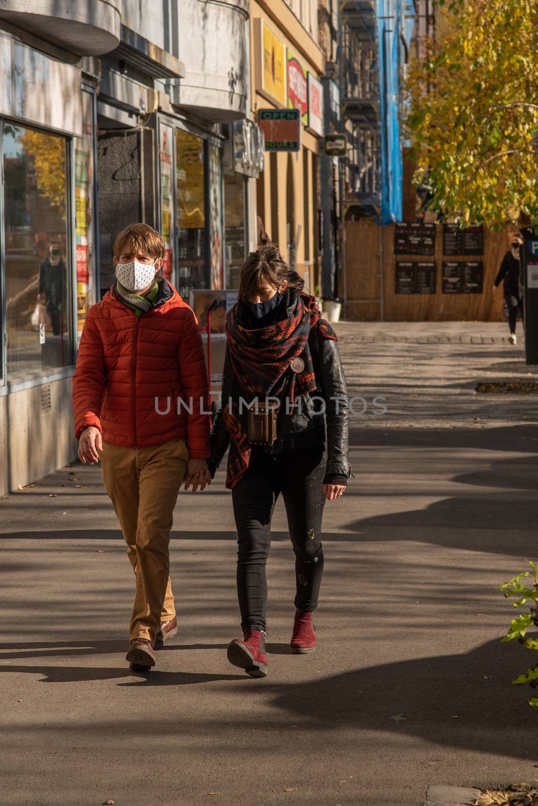 11-22-2020. Prague, Czech Republic. People during quarantine period due to coronavirus (COVID-19) at Hradcanska metro stop in Prague 6. friends walking.