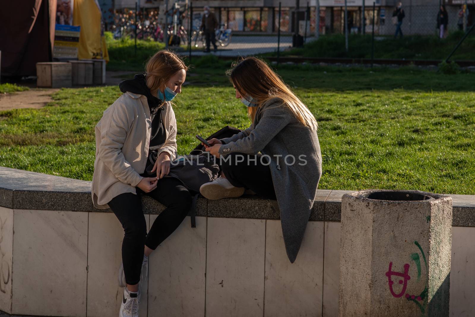 11-22-2020. Prague, Czech Republic. People during quarantine period due to coronavirus (COVID-19) at Hradcanska metro stop in Prague 6. Girlfriends talking.