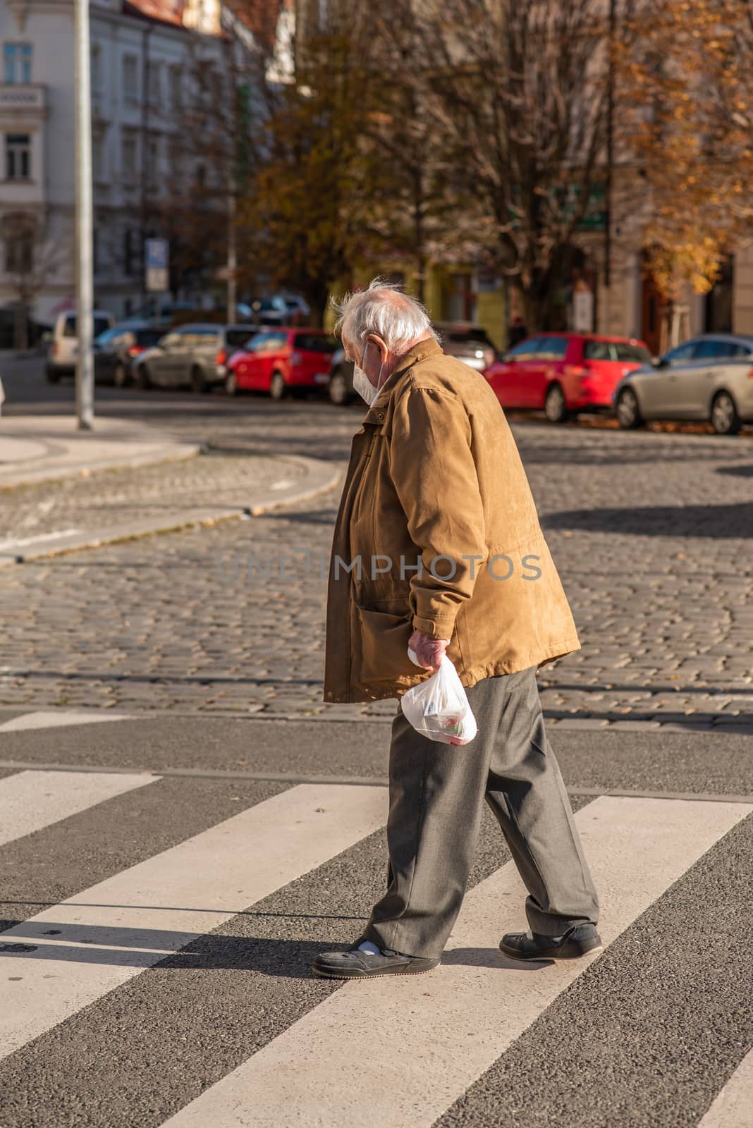 People on a sunny winter day during coronavirus. Last suny days. People are walking, doing some sports or having time to relax. Prague 6, Czech Republic. by gonzalobell