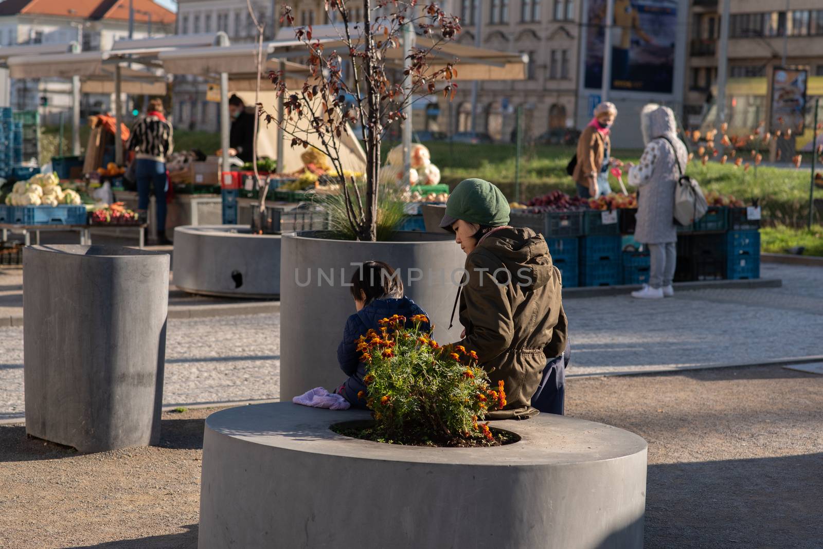 11-22-2020. Prague, Czech Republic. People during quarantine period due to coronavirus (COVID-19) at Hradcanska metro stop in Prague 6. Mother and son eating.