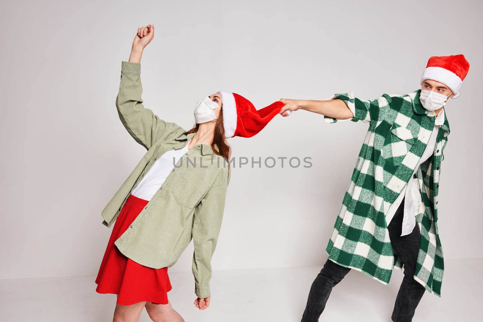 young couple christmas hats holiday emotions fun together. High quality photo