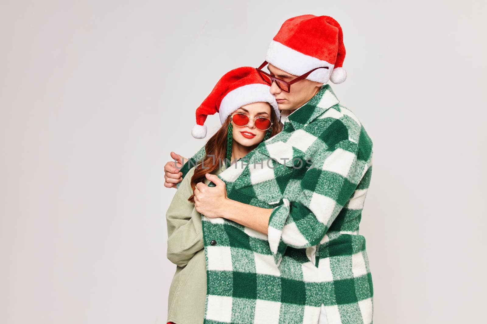 young couple green plaid shirt hugs holiday fun. High quality photo