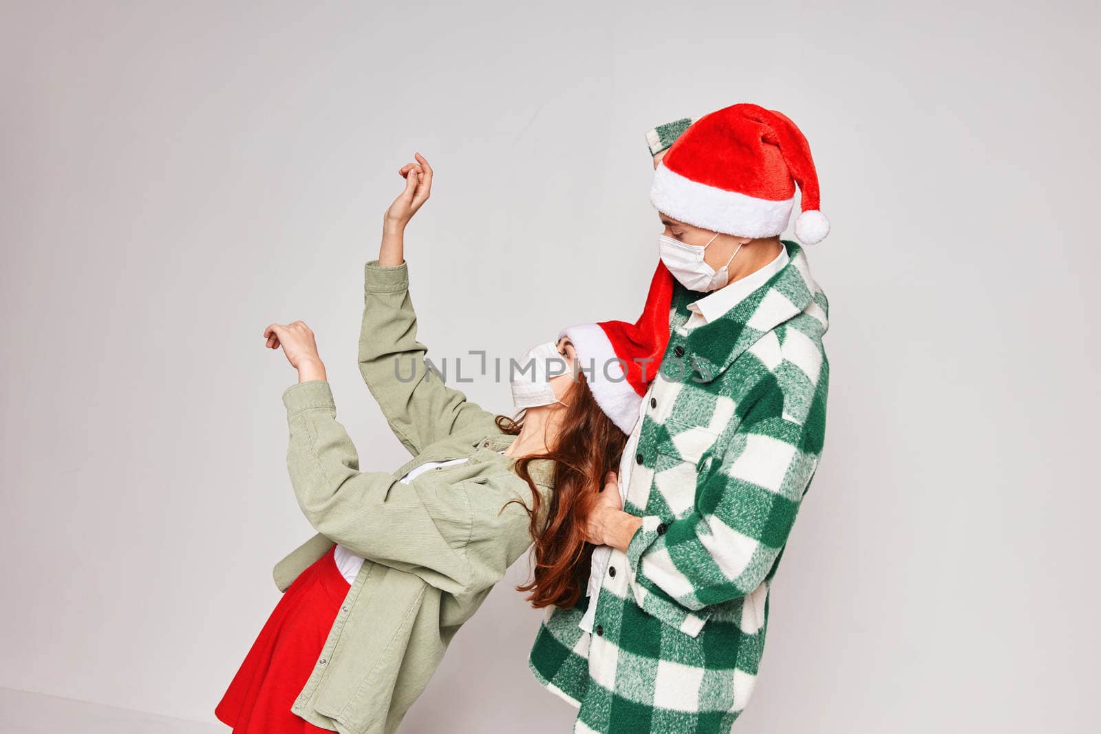man and woman wearing medical masks fun new year winter holiday together. High quality photo