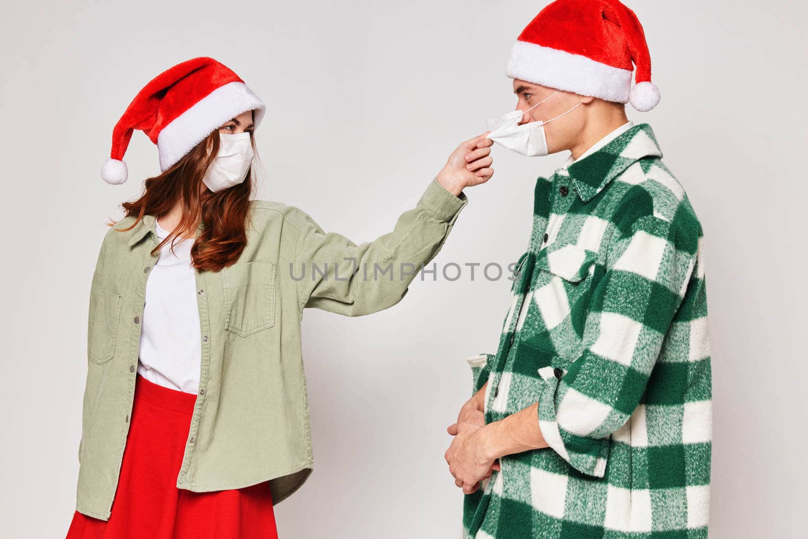 man and woman wearing medical masks new year holiday protection studio. High quality photo