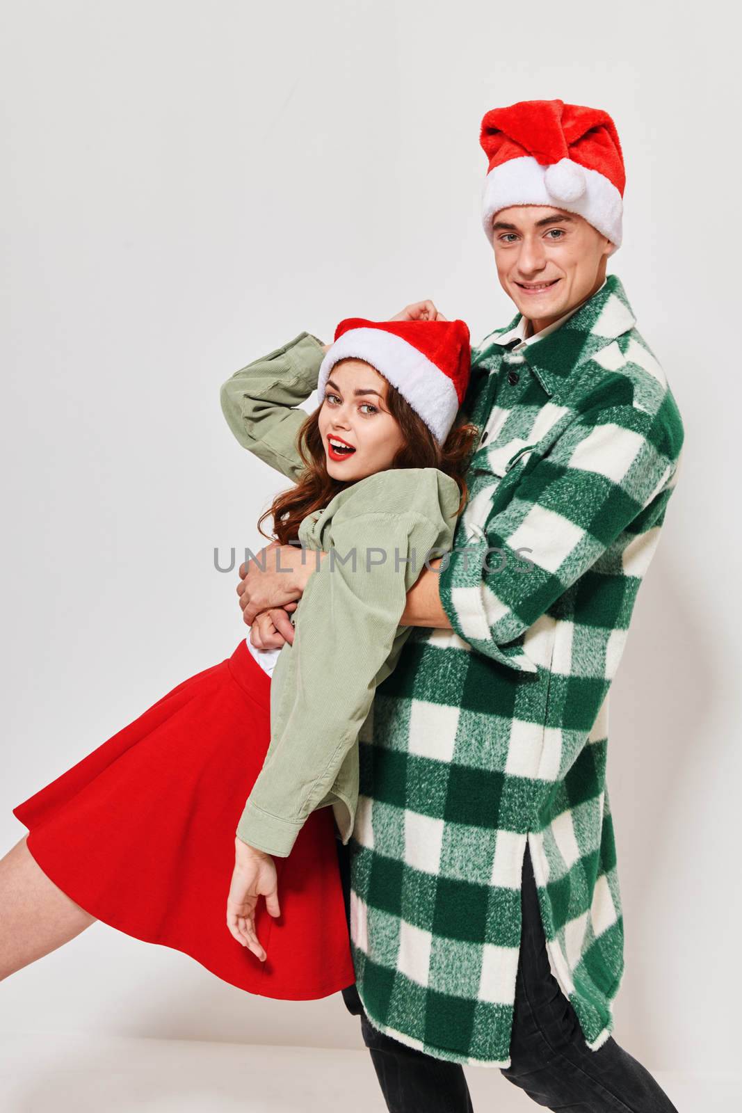 Cheerful young couple in New Year's clothes holiday emotions studio. High quality photo