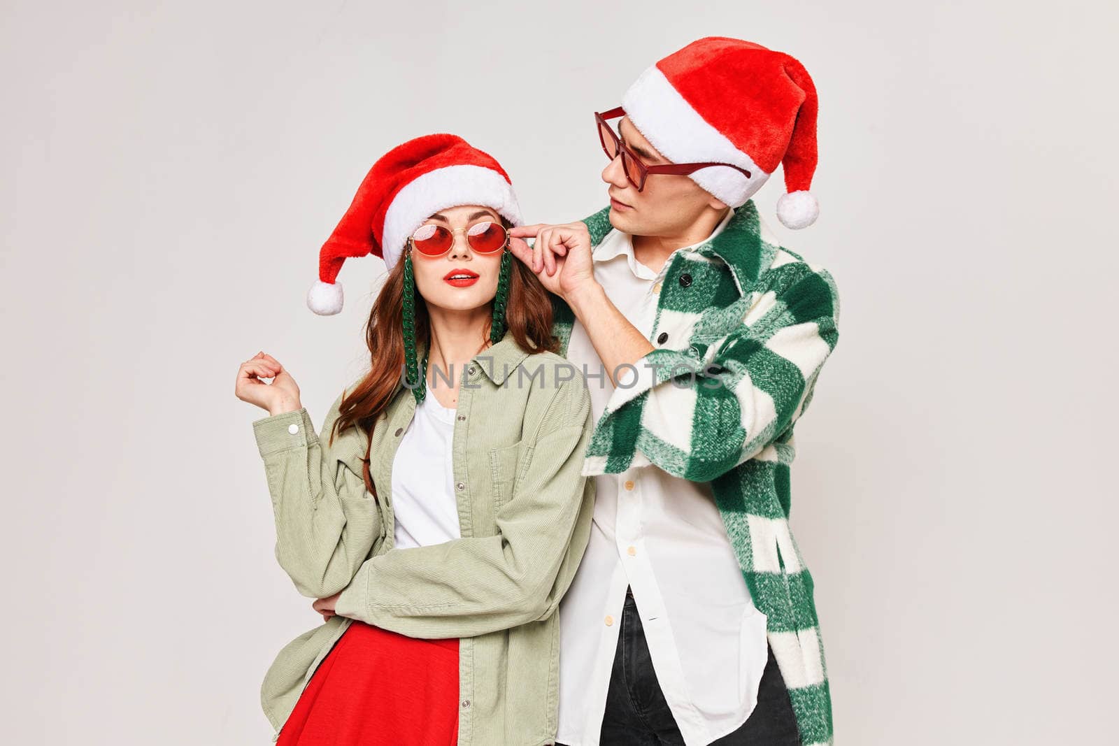 Man and woman in Christmas hats Christmas fun celebration together by SHOTPRIME