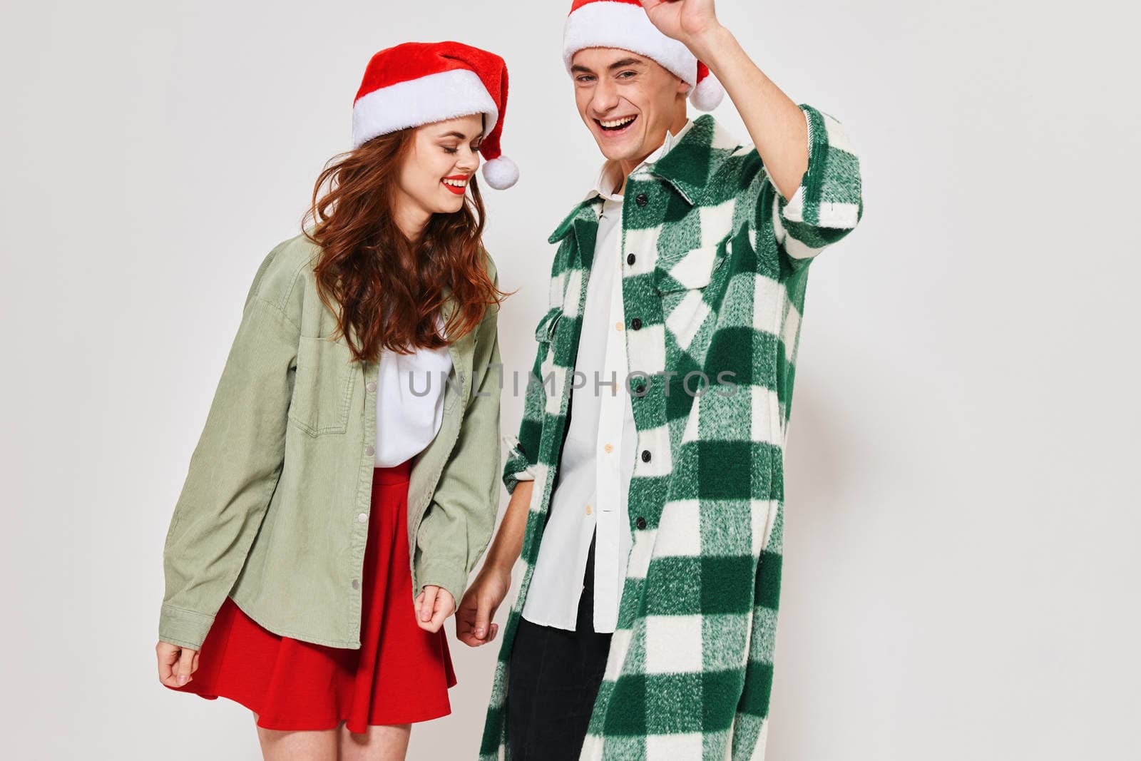 young couple wearing new year clothes fashion holiday studio together by SHOTPRIME