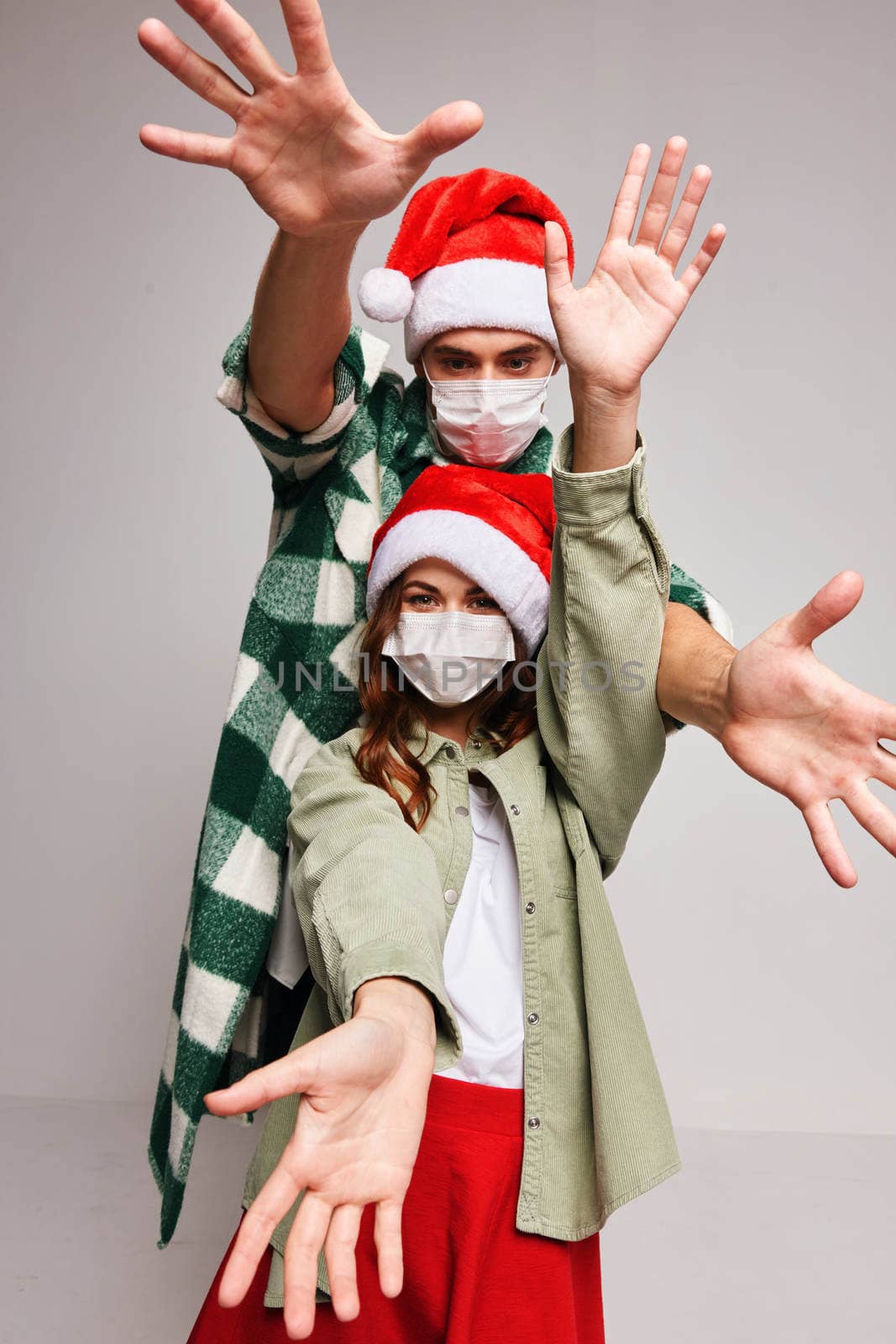 Man and woman in medical masks Christmas holiday New Year friendship. High quality photo