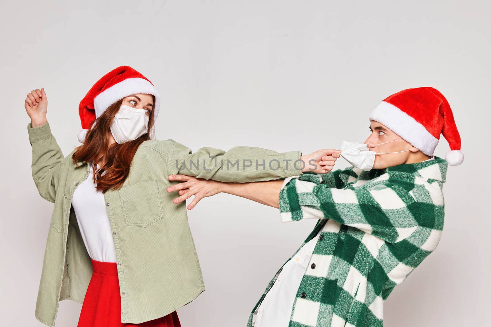 Family couple in Christmas hats medical masks emotions holiday New Year. High quality photo