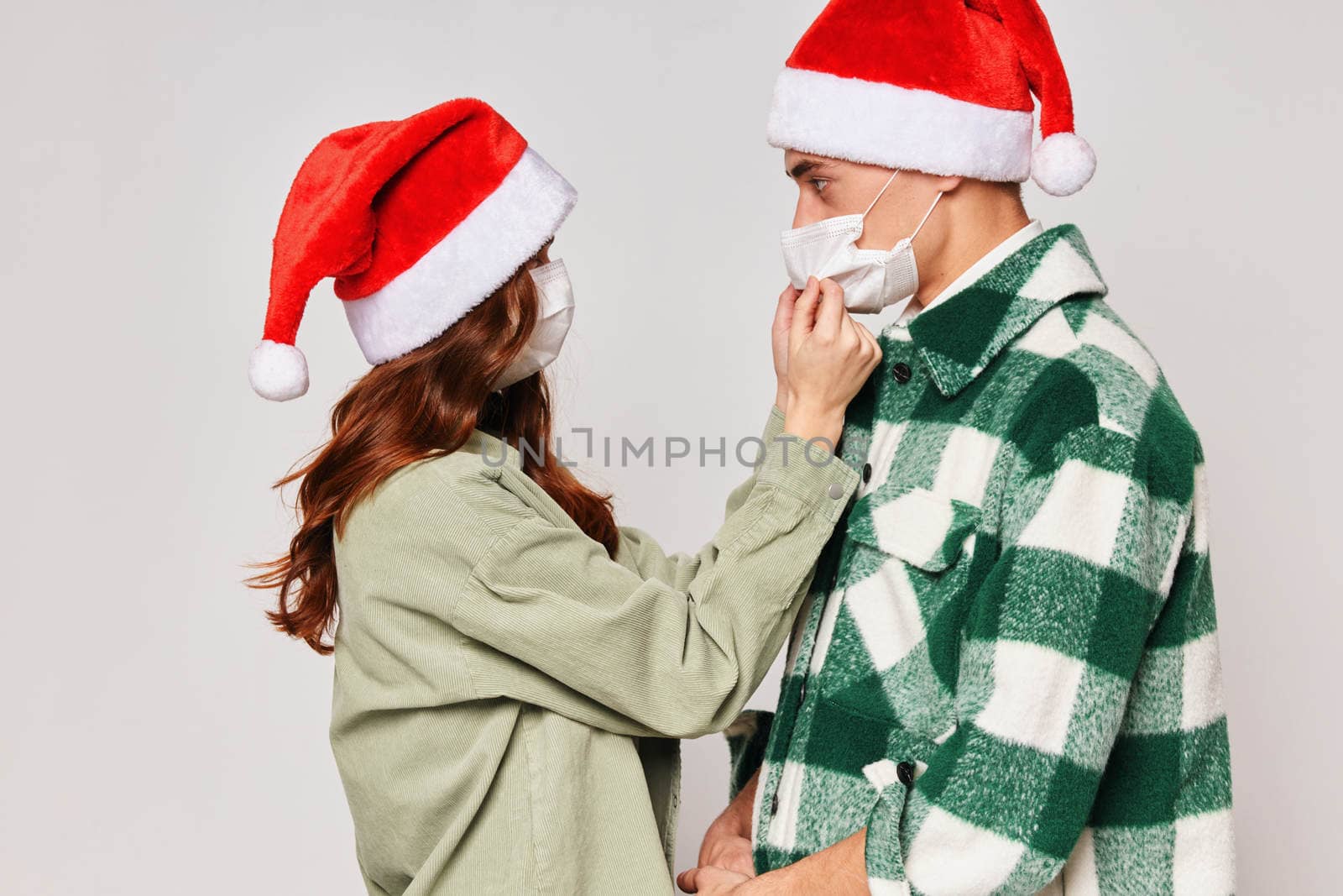 man and woman wearing medical masks care protection new year holiday by SHOTPRIME