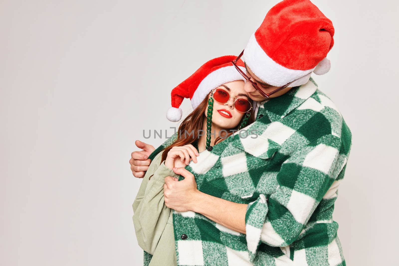 man warms woman hugs new year holiday sunglasses. High quality photo