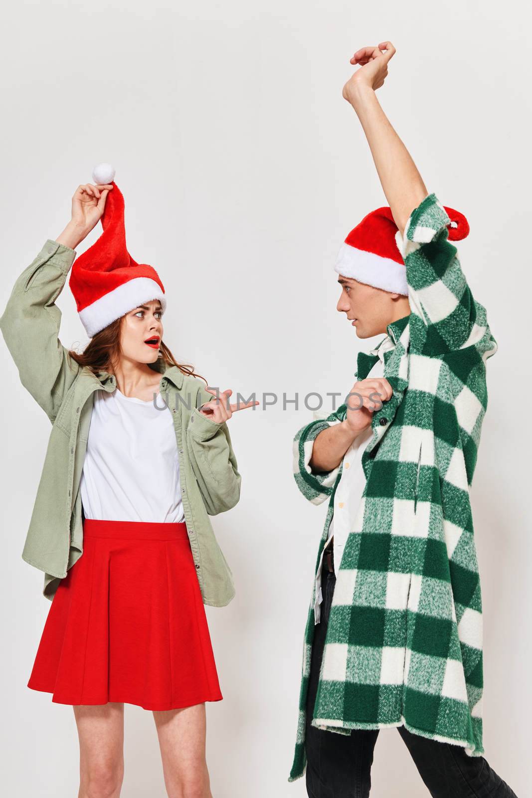 Cheerful young couple celebrating New Years with hands raised up by SHOTPRIME